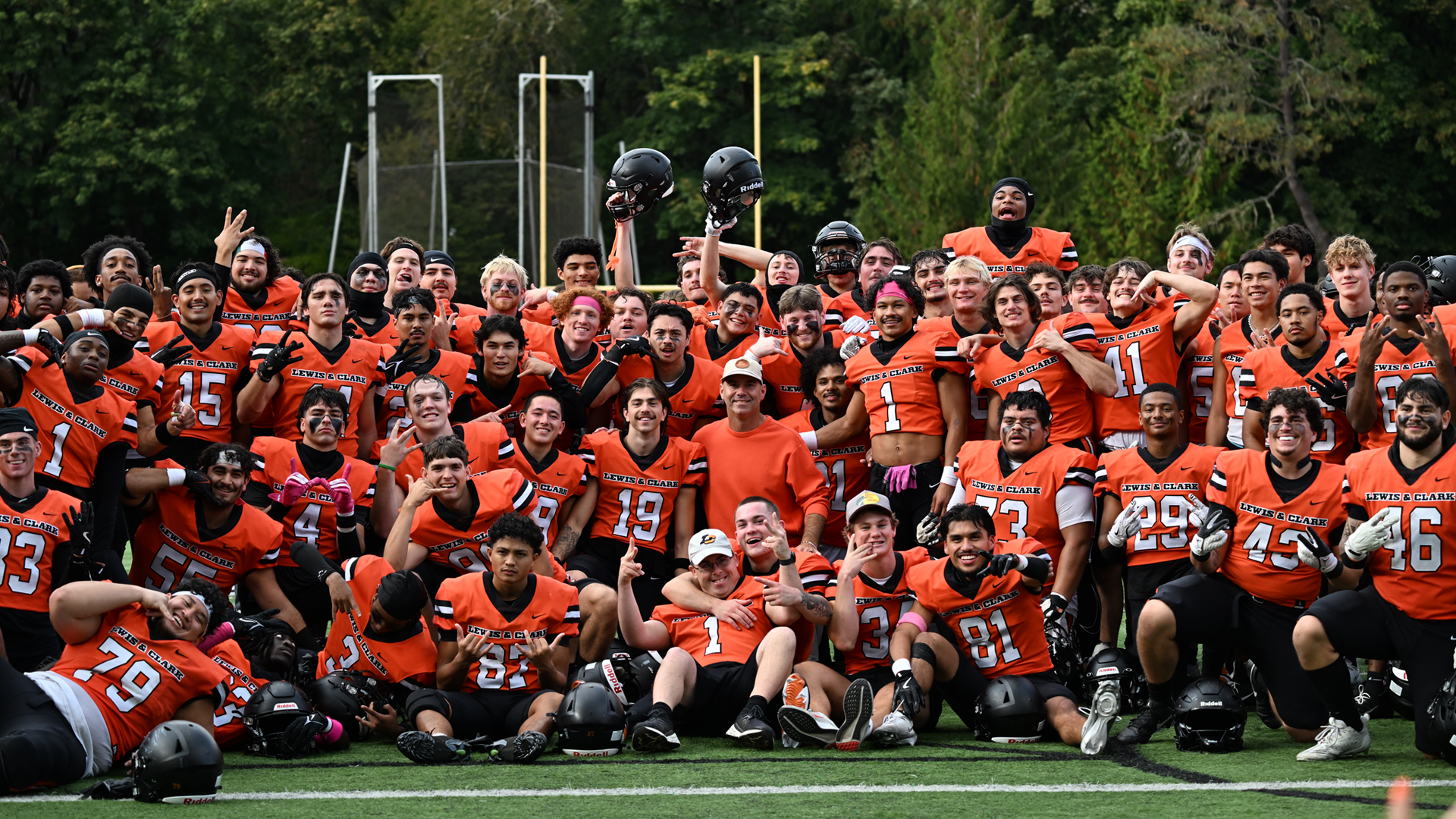 Football group celebration photo after win over Puget Sound