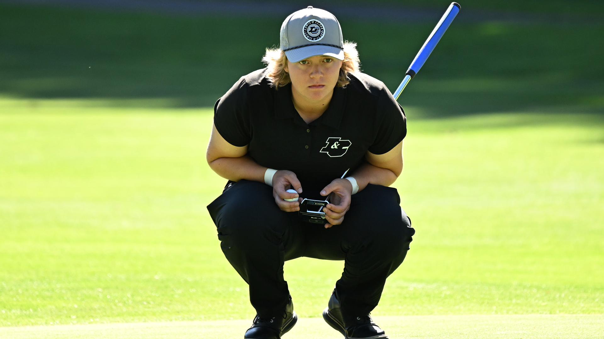 Darywn Kormany looks at the hole as she evaluates her putting line