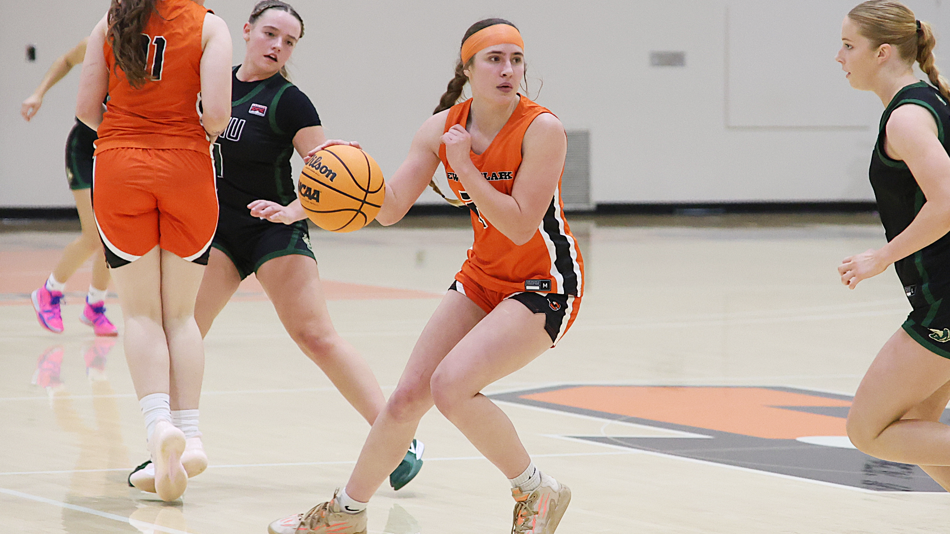 Kinnedy Scott dribbles the ball and looks down court. 