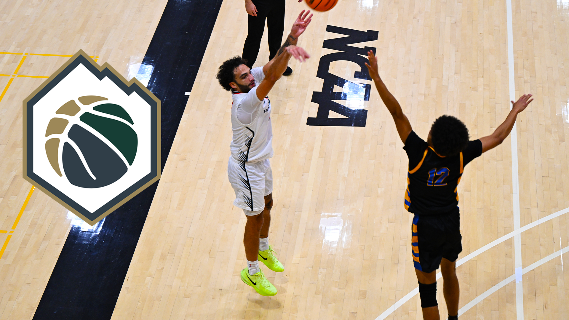 Andre Treadwell shoots a three pointer over a defender. 