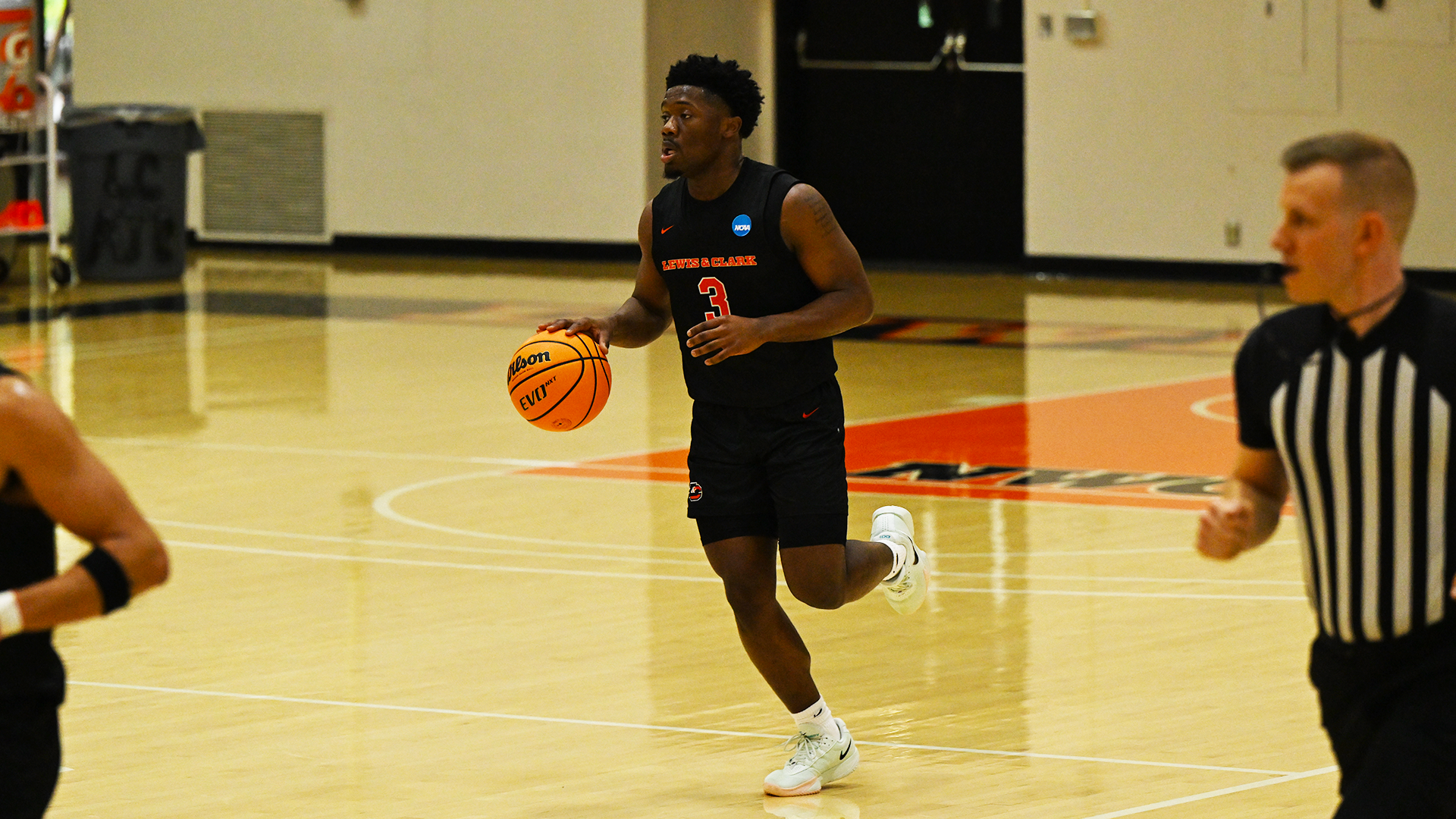 Jayven Jones dribbles the basketball down the court. 