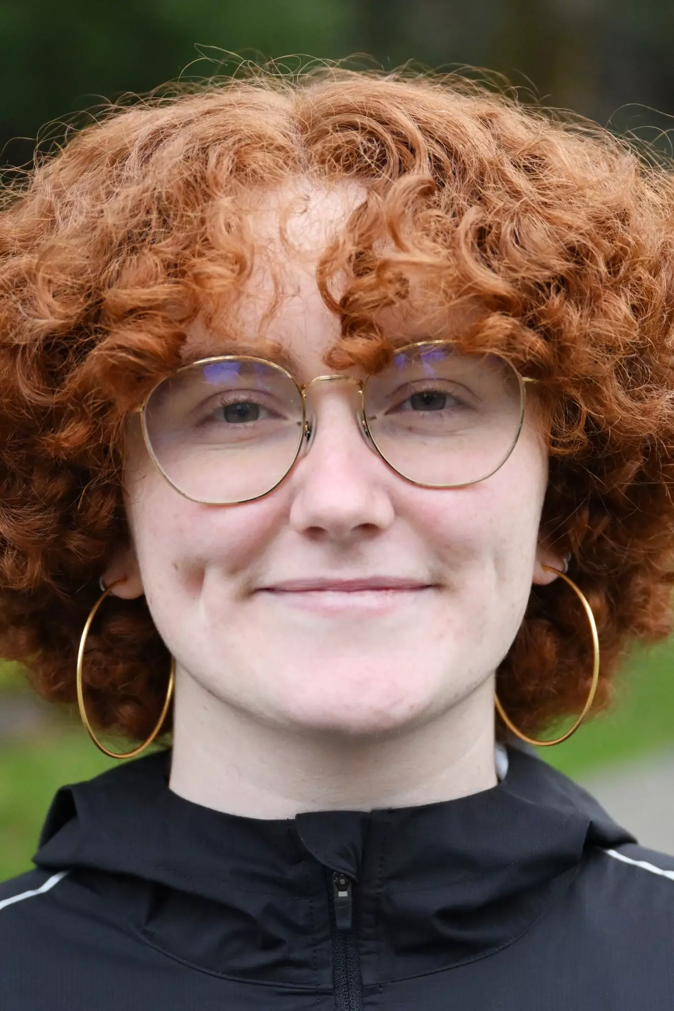 Piper McCoy Harmon smiles in front of a green background