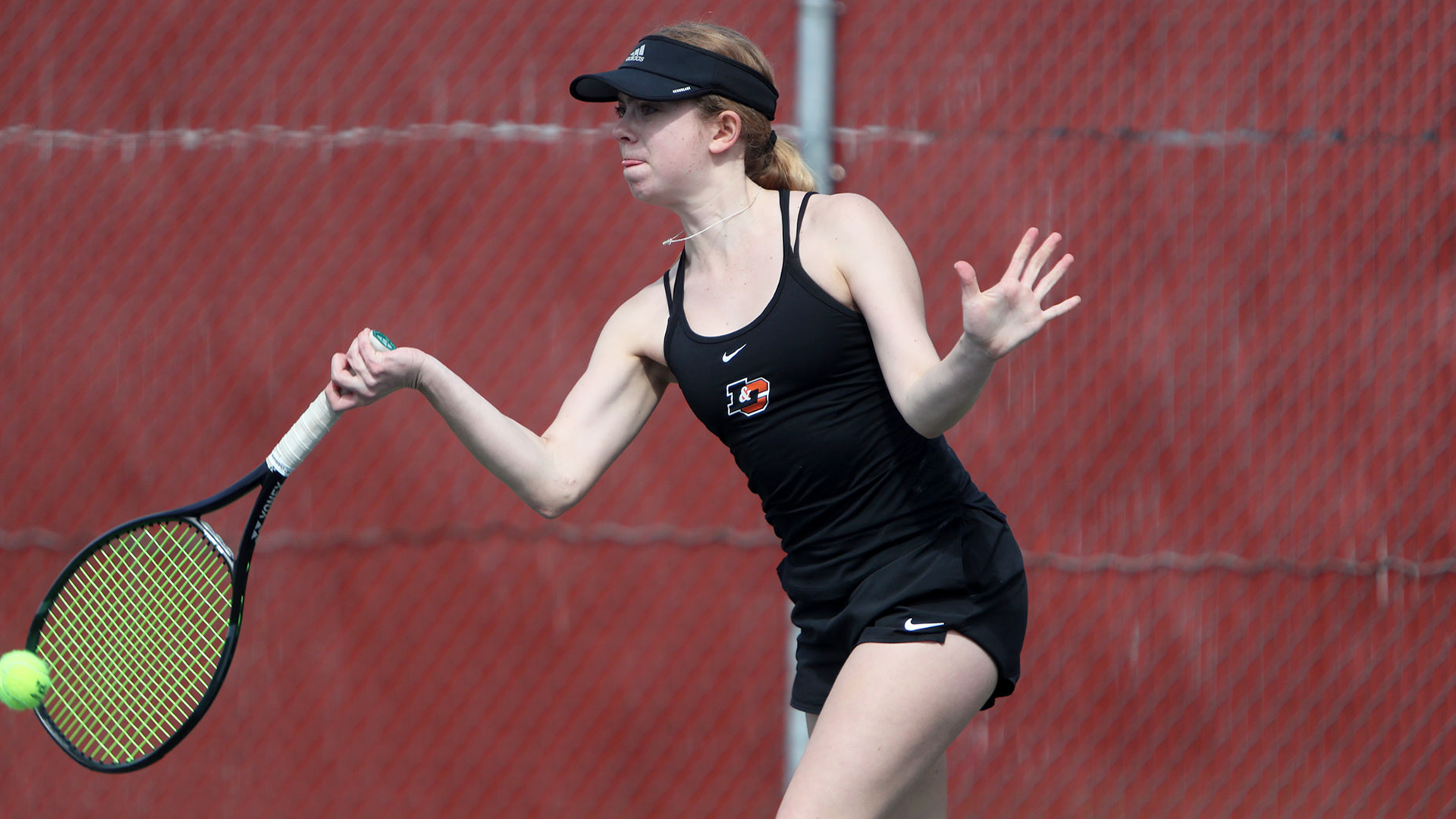 Anna English hits a forehand.
