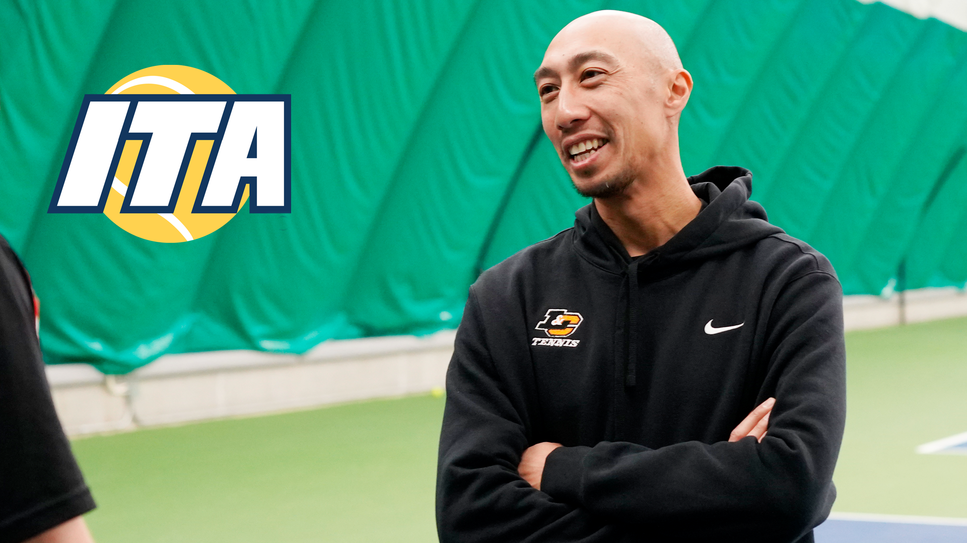 Phalkun Mam smiles while chatting with a Pioneers player