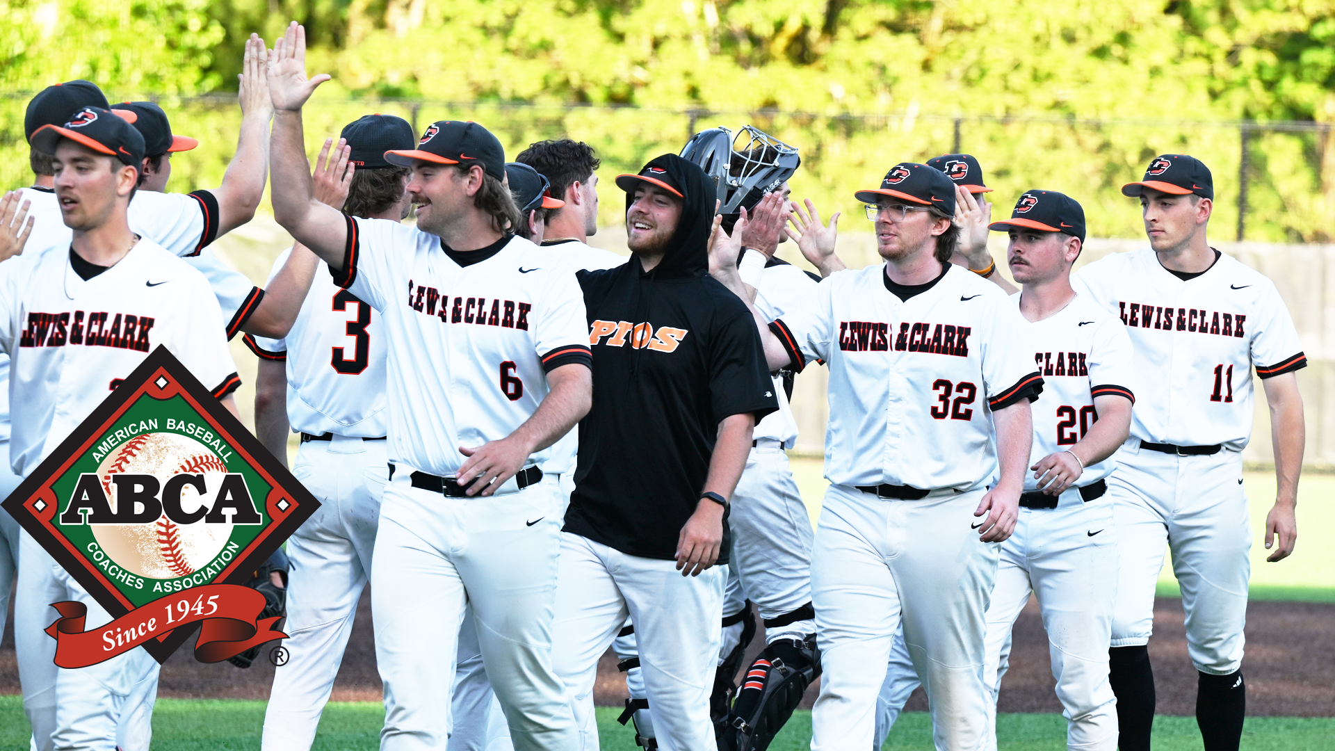 Baseball players line up and high five after a win 