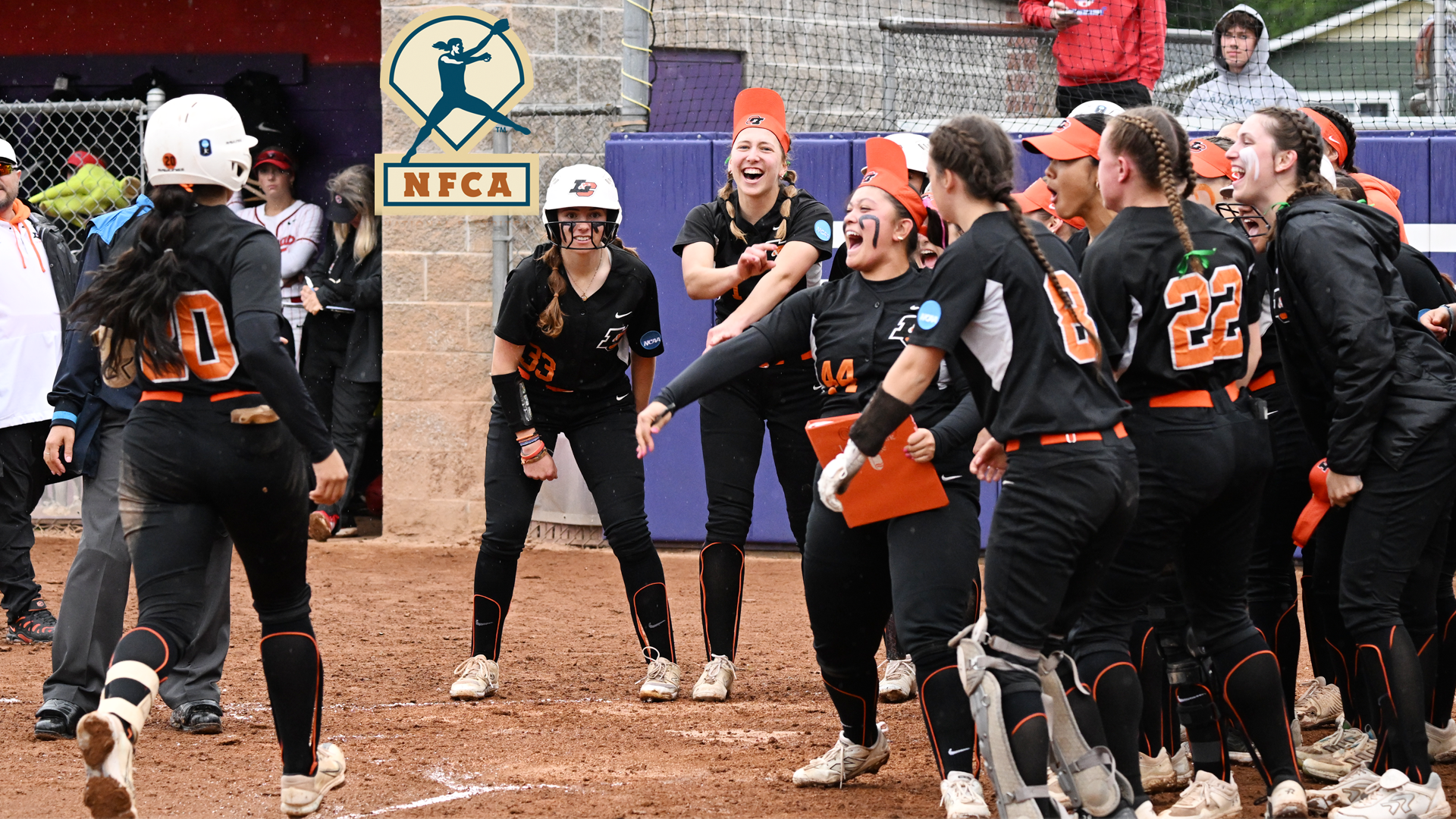 Softball surrounds home plate and celebrates Mari Alvarez's walk-off home run