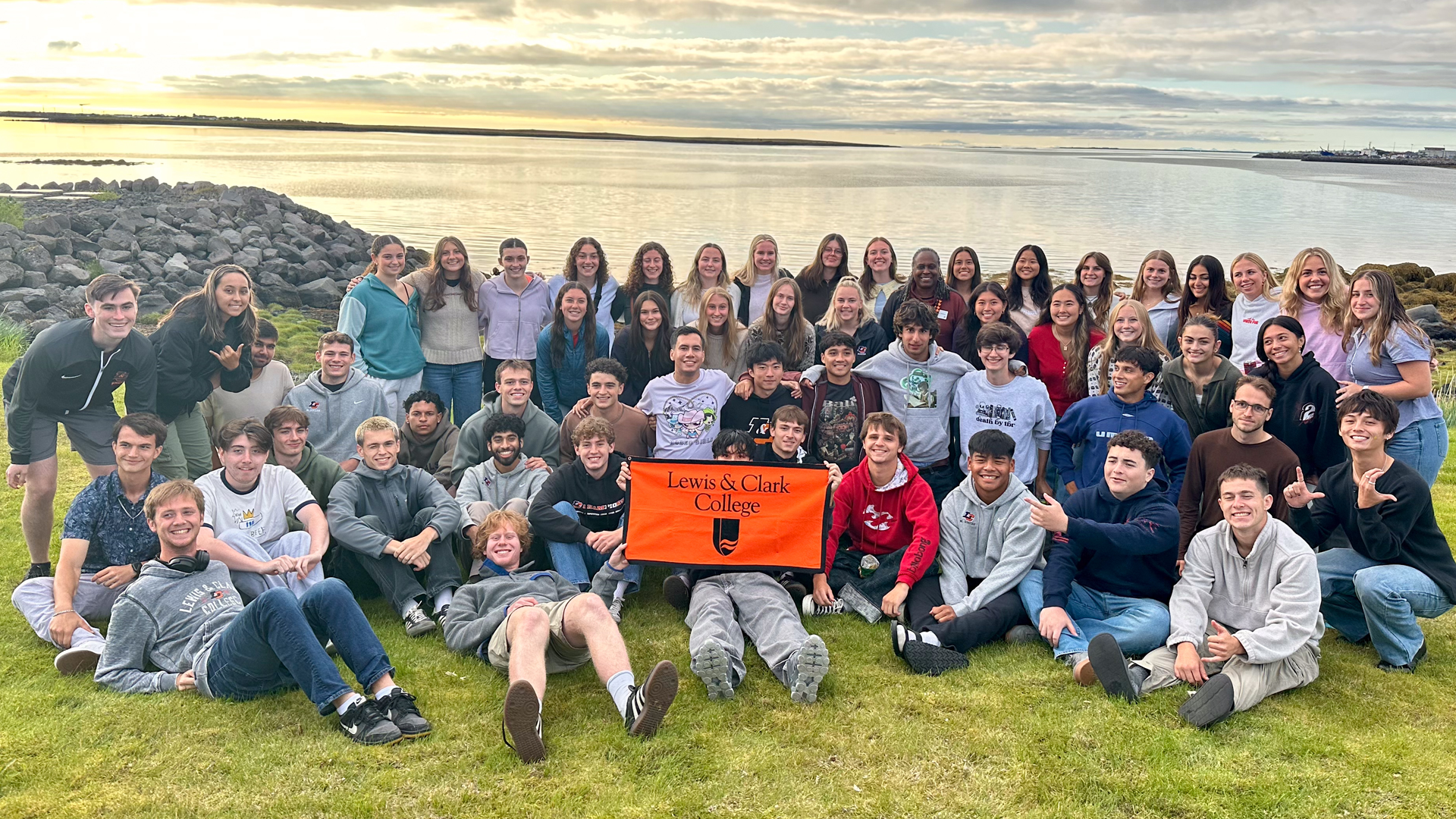 Men's and women's soccer pose for a group photo in Iceland with President Dr. Robin Holmes Sullivan