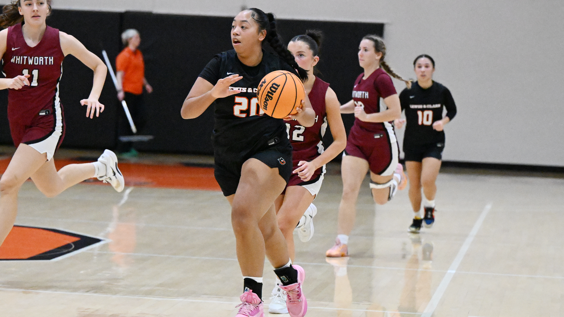 Ky Roussin dribbles the basketball against Whitworth