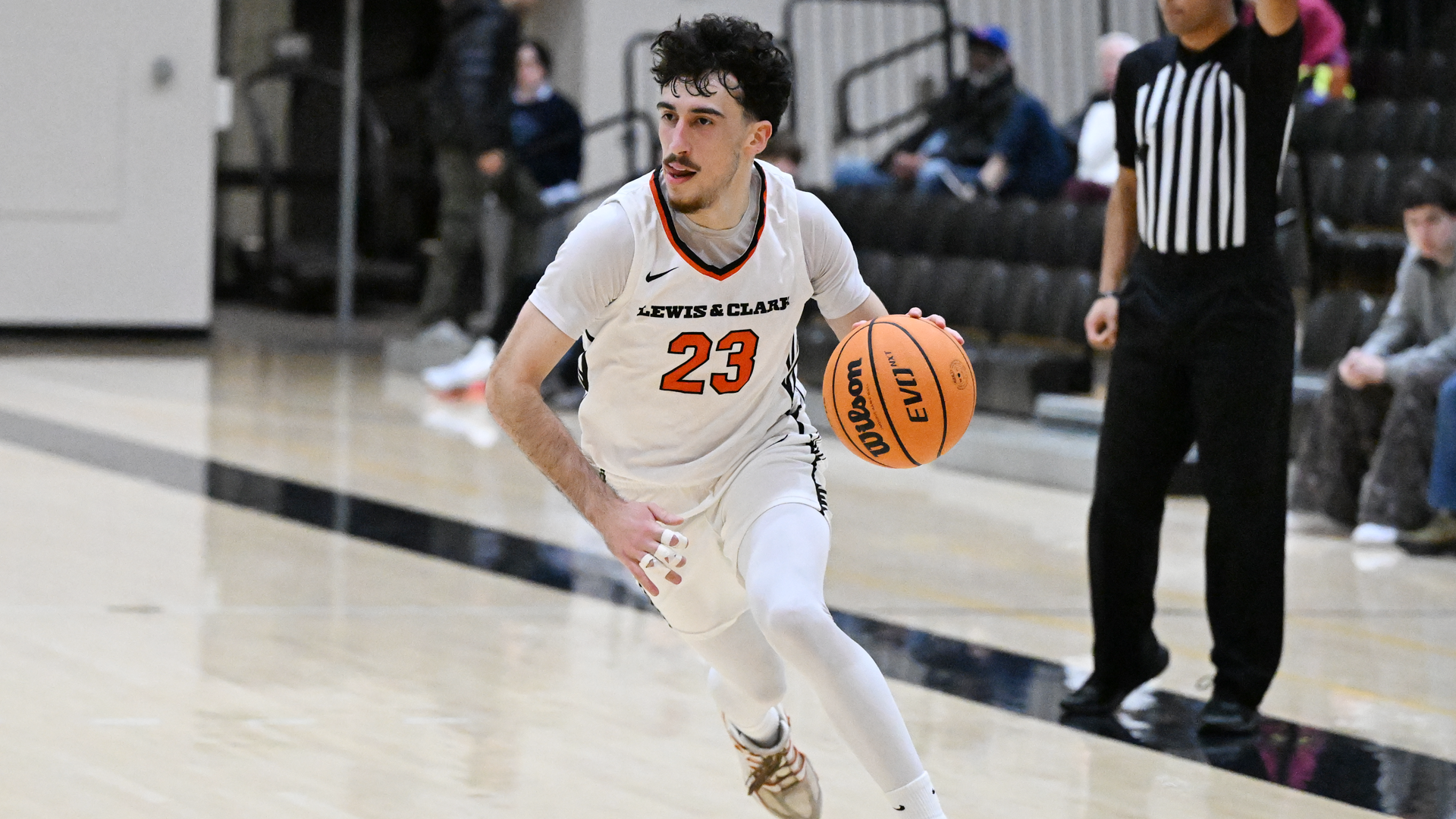 Yigit Arcan dribbles the basketball at the edge of the 3-point line