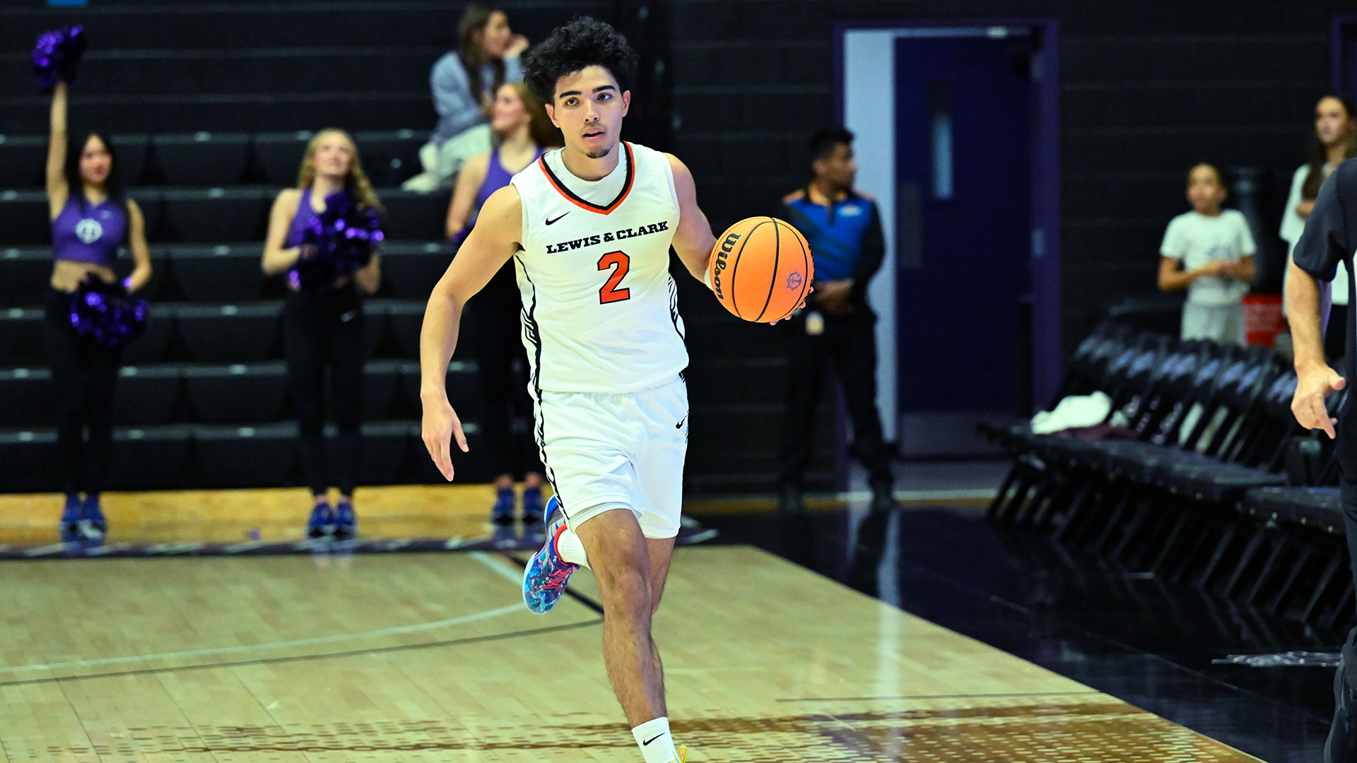 Taien Jackson dribbles the basketball down the court. 