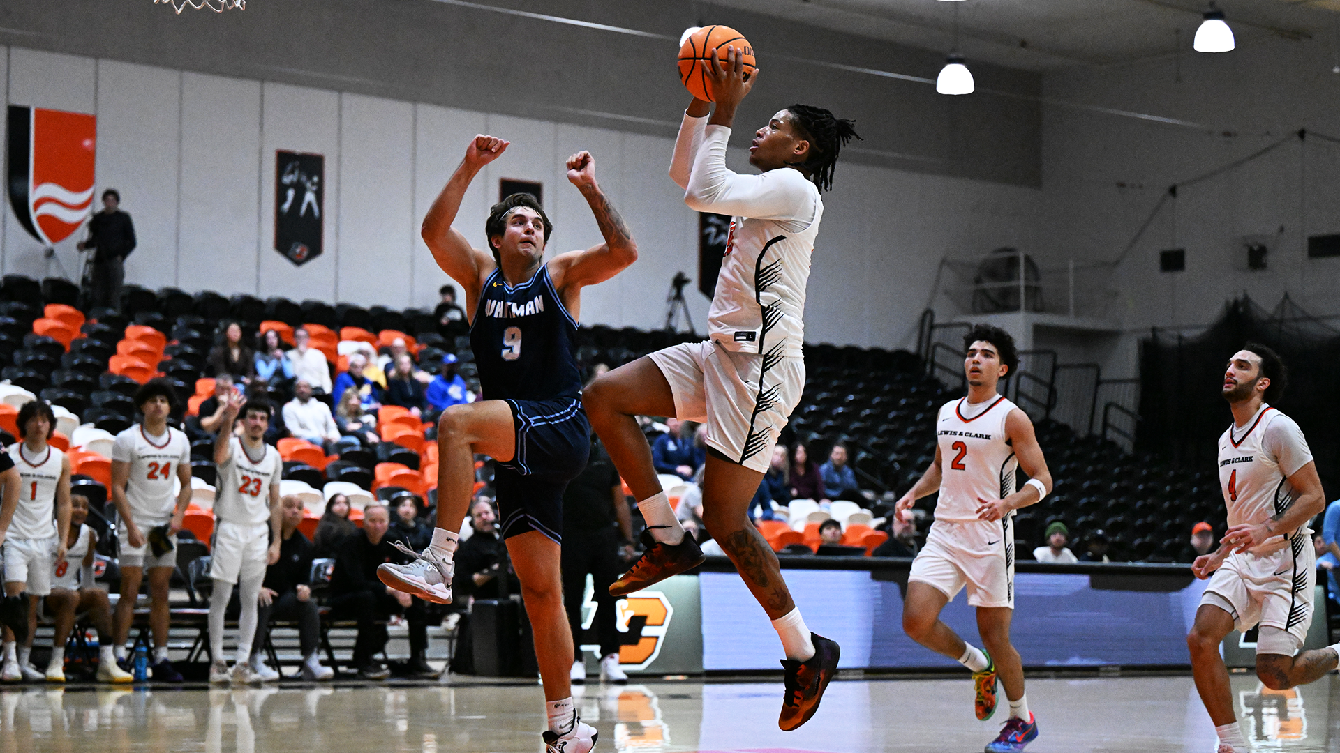 Justin White drives to the hoop against a defender. 