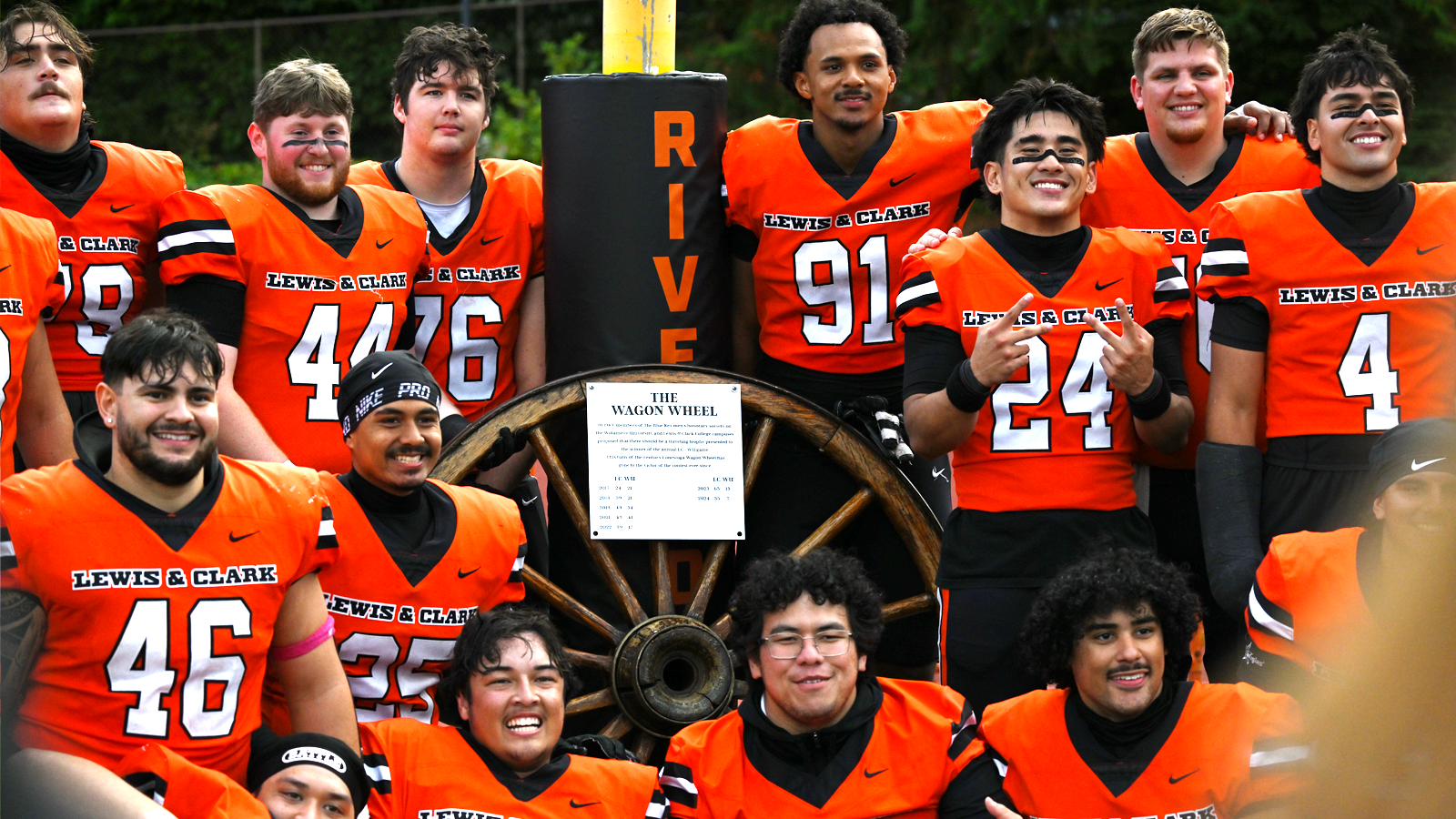 Seniors pose with the Wagon Wheel after defeating Willamette in 2026