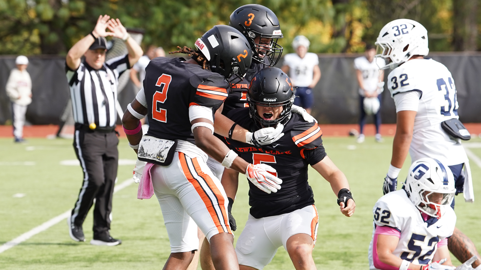 Ethan Koo celebrates with his teammates after a blocked punt and recovery on Homecoming
