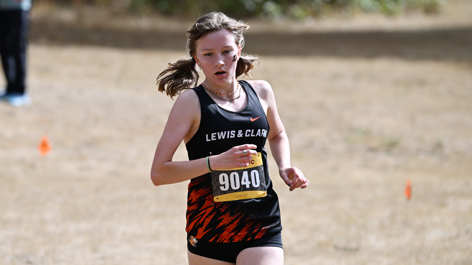 Talia Tomhave runs up a hill at the L&C XC Opener