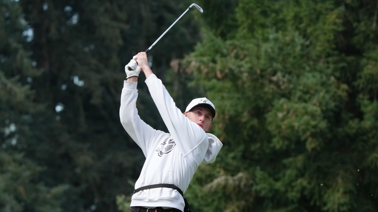 Luke Blankinship hits an iron shot and watches it fly towards the green