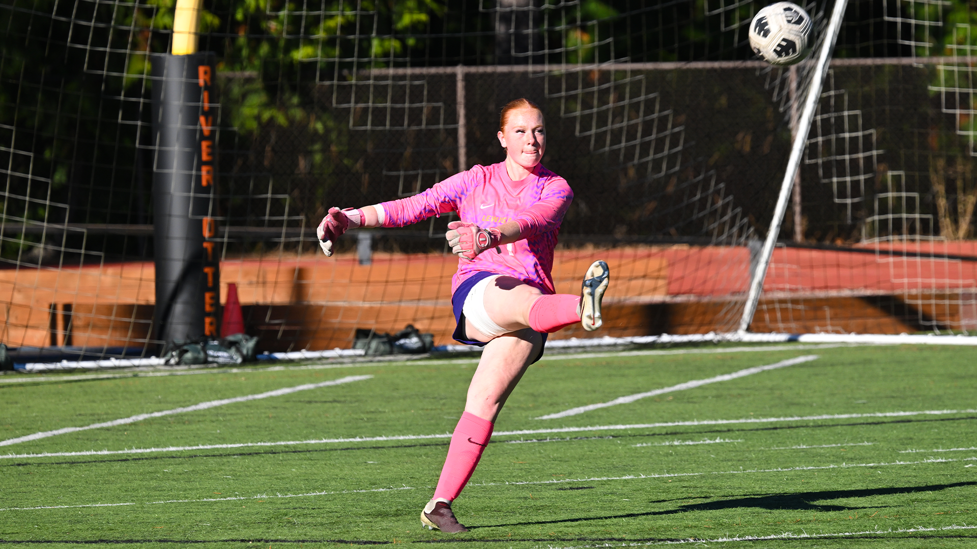 Mallory Symons kicks the ball out of the goal.