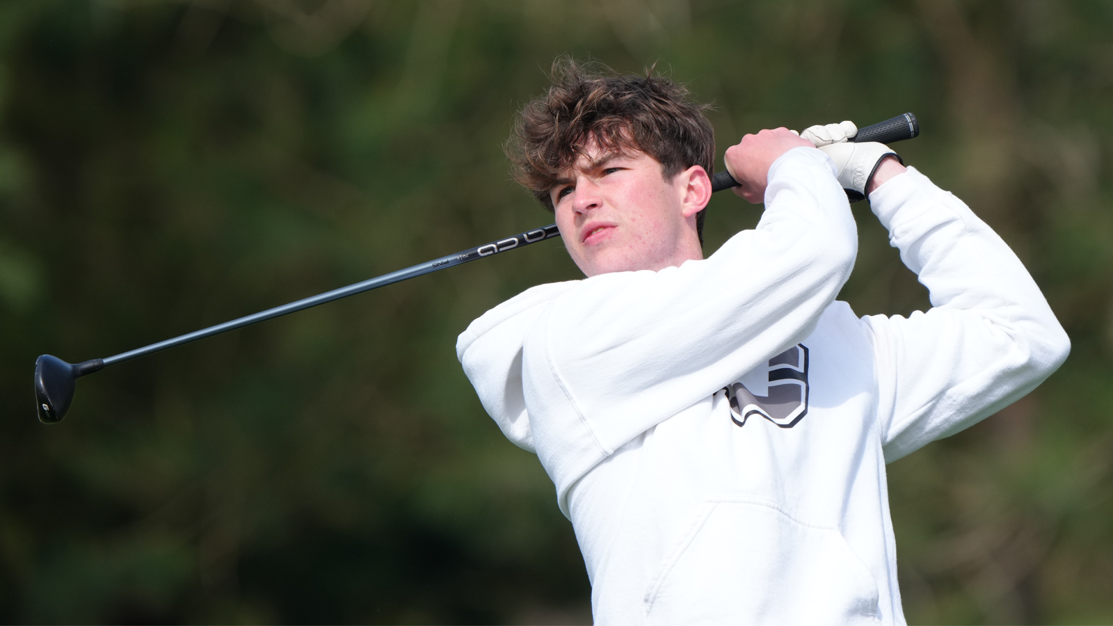 Trae Fredrickson watches his drive fly down the fairway