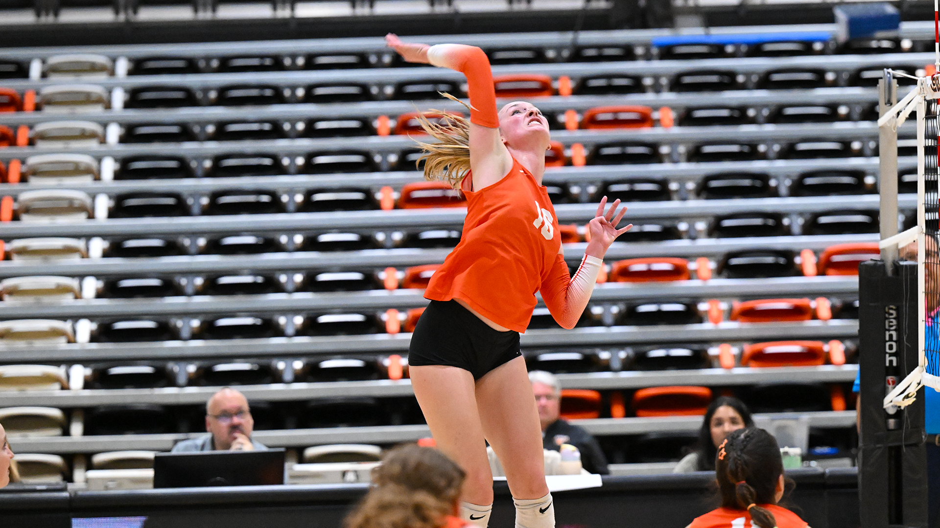 Kaitlyn Jensen hits the volleyball against George Fox