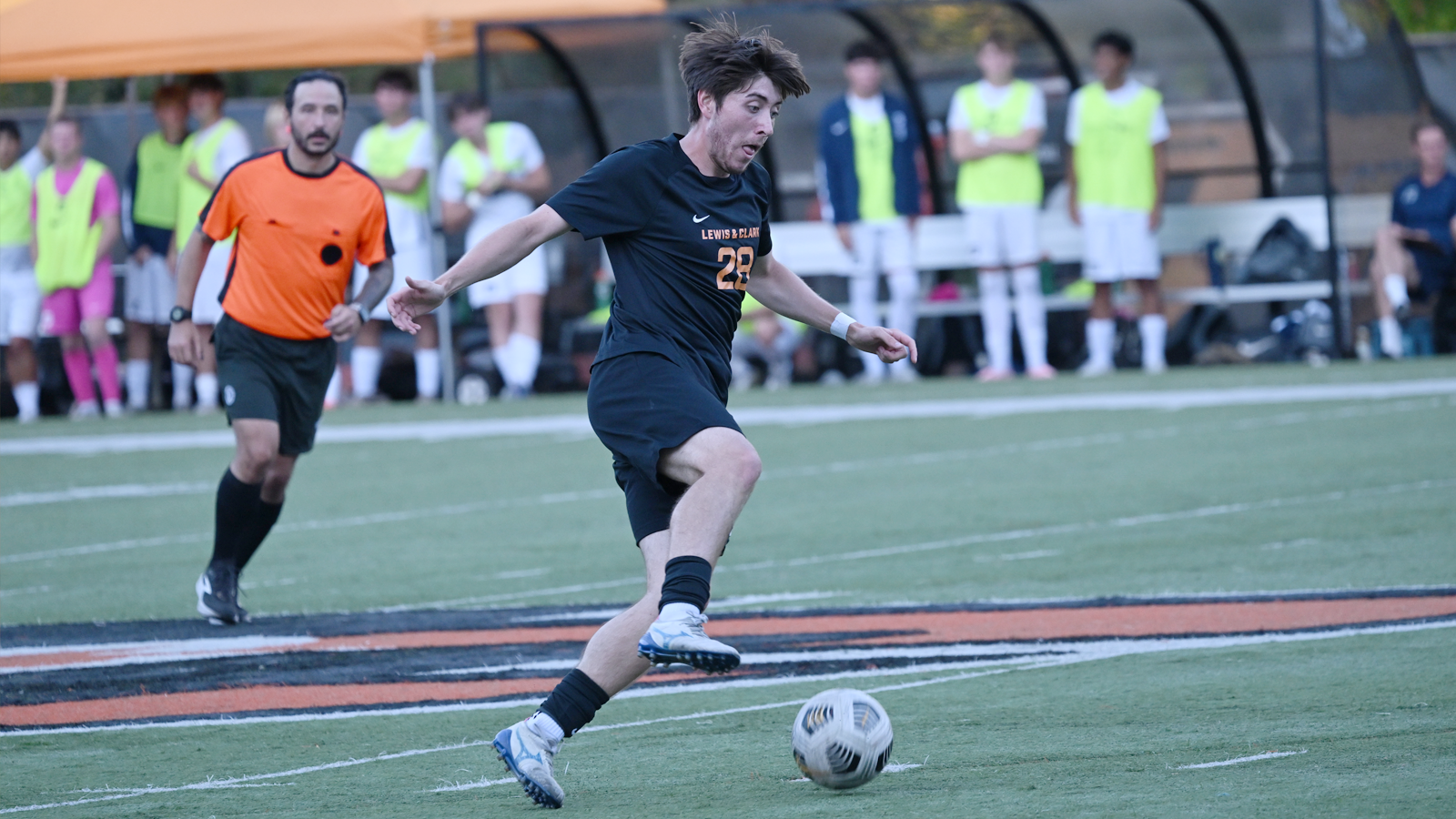 Brody Kennedy dribbles with the ball against George Fox