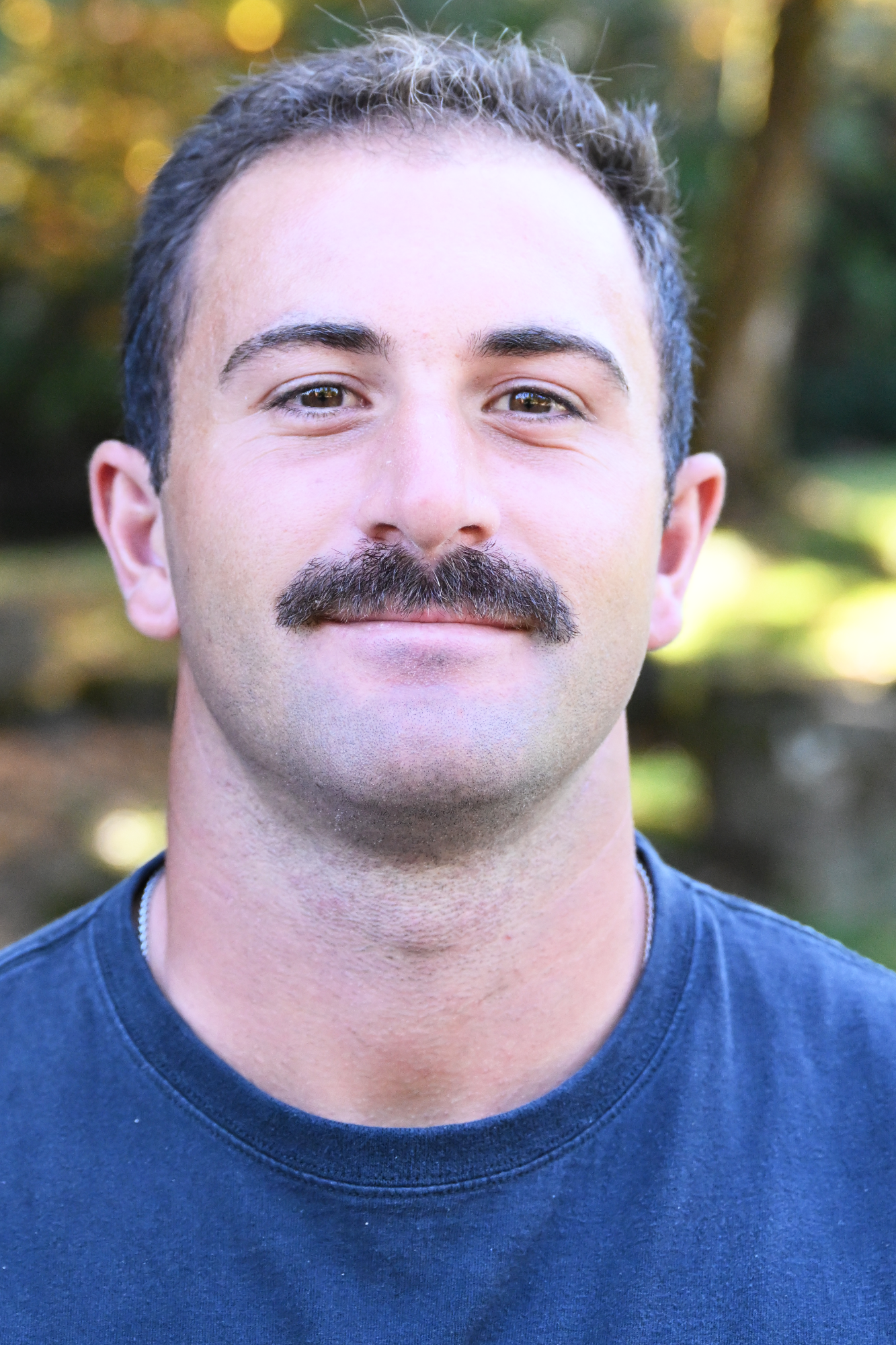 Jack Thomson smiles in front of a green background