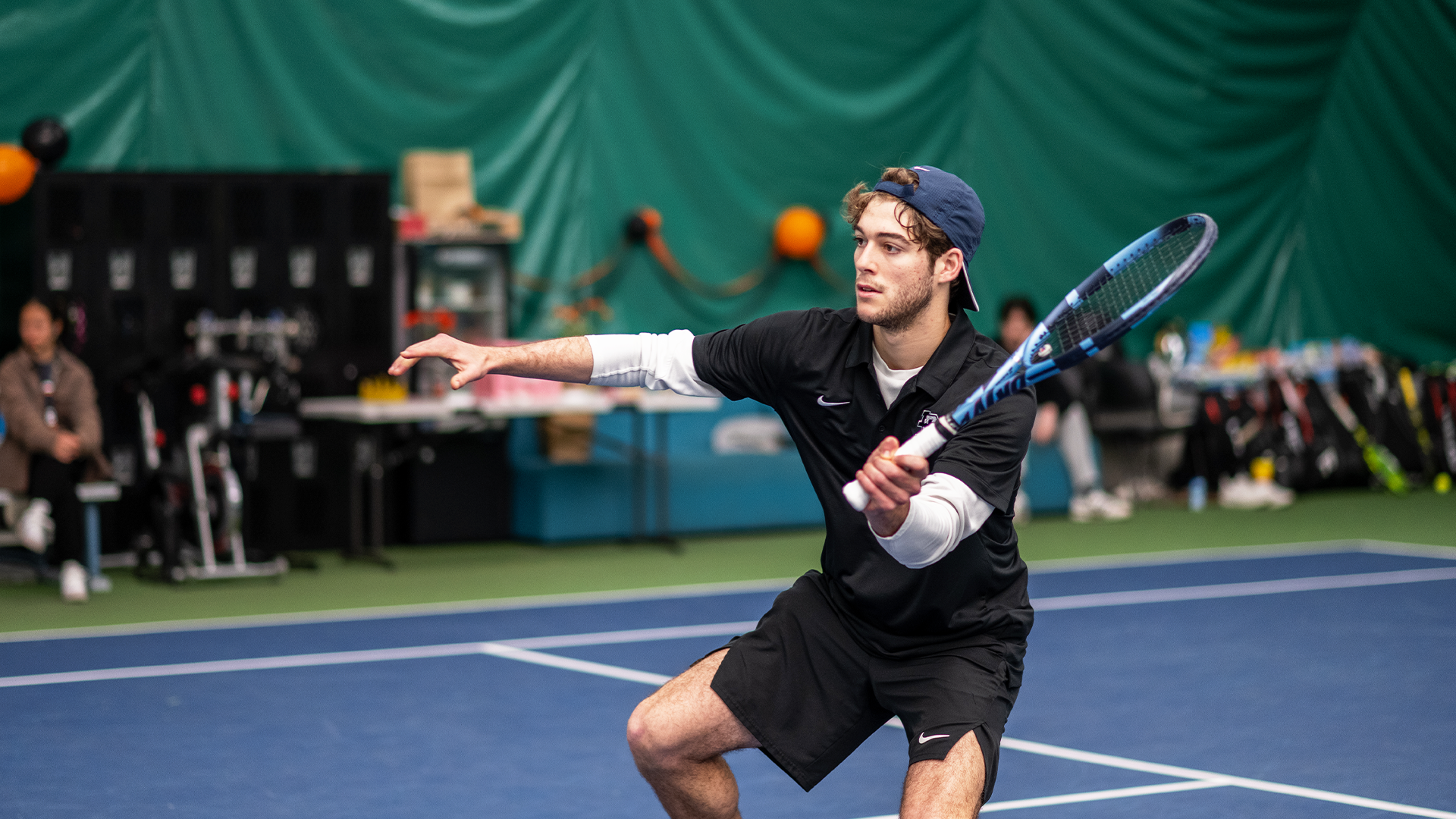 Noah Sutin hits a volley in a match. 