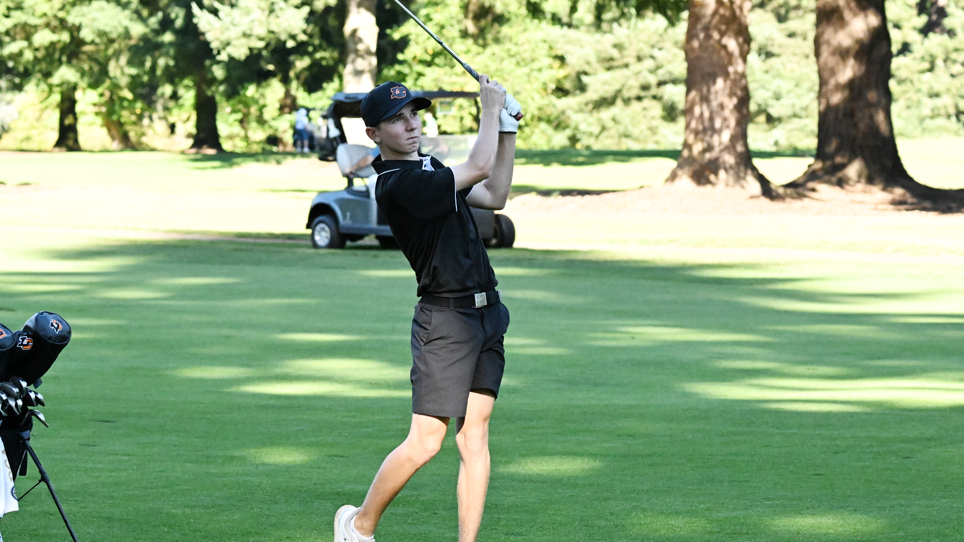 Brady Gless watches an iron shot fly towards the green