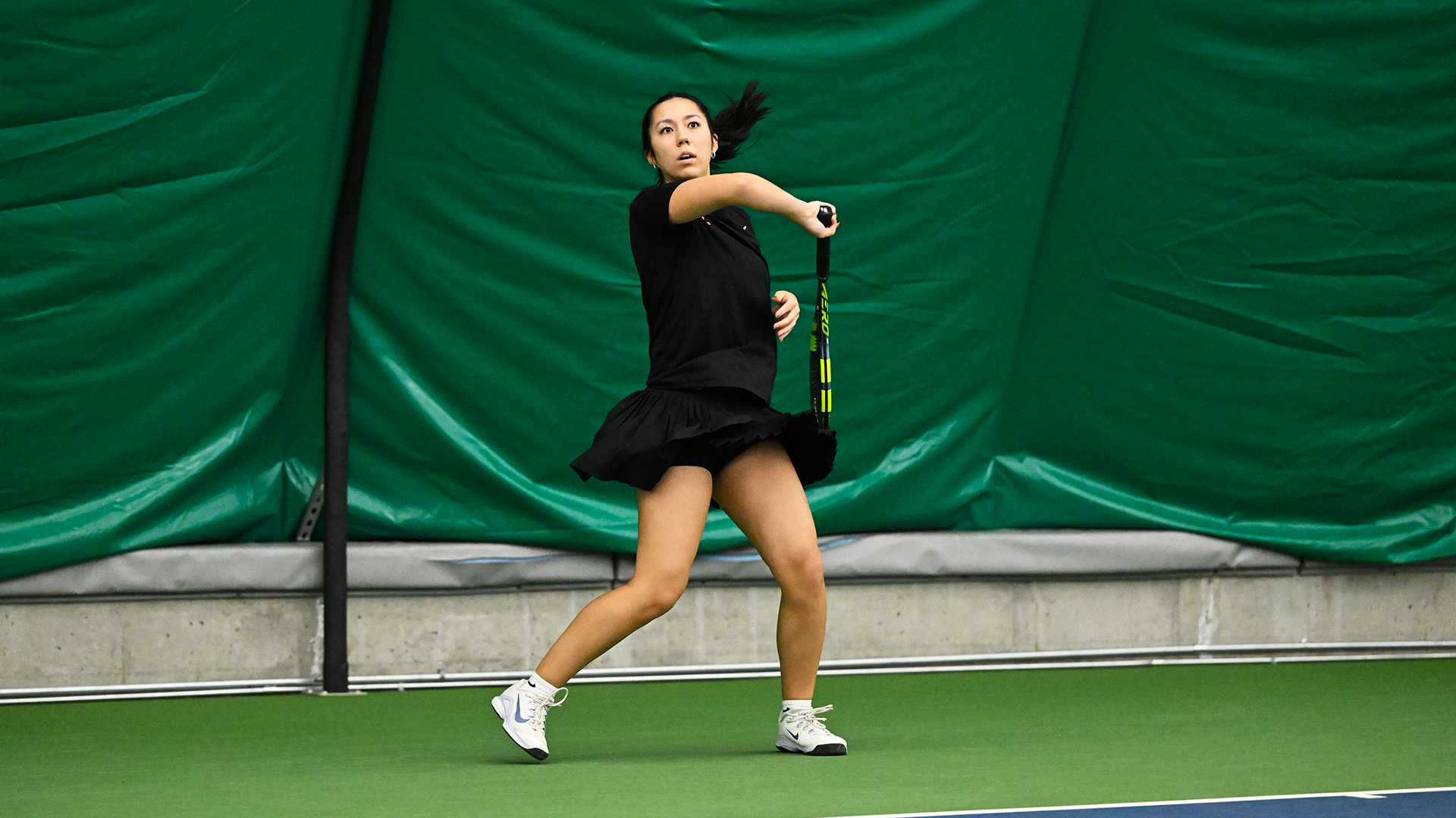 Alex Mignogna hits a baseline forehand shot. 