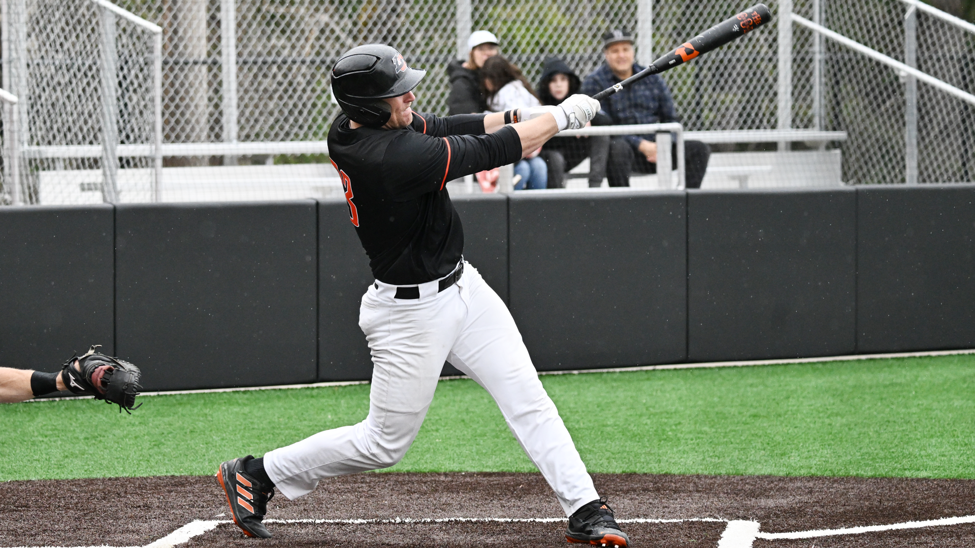Bret Potter swings and hits the ball to the outfield