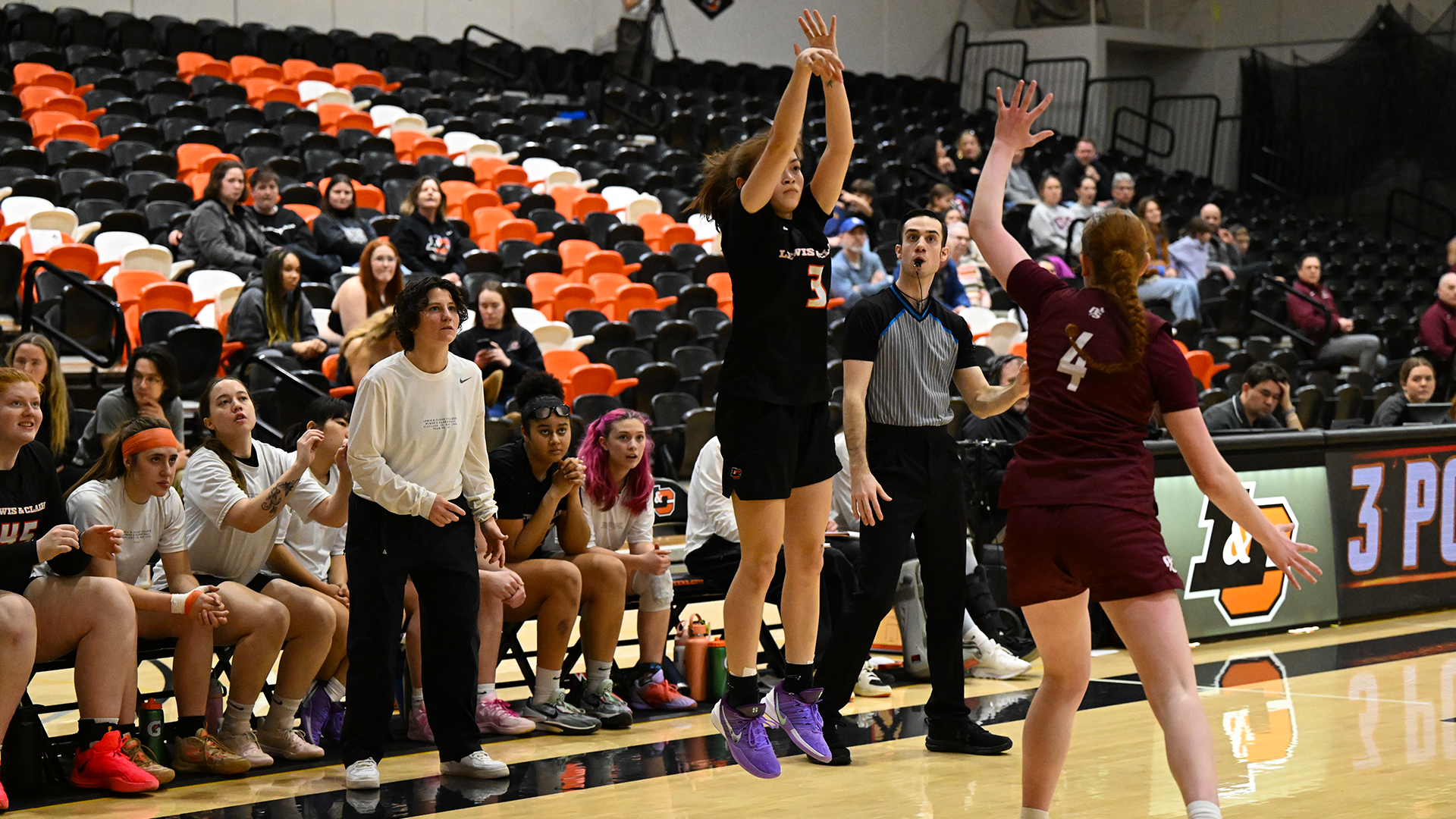 Kaitlen Carns shoots a three pointer against a defender. 