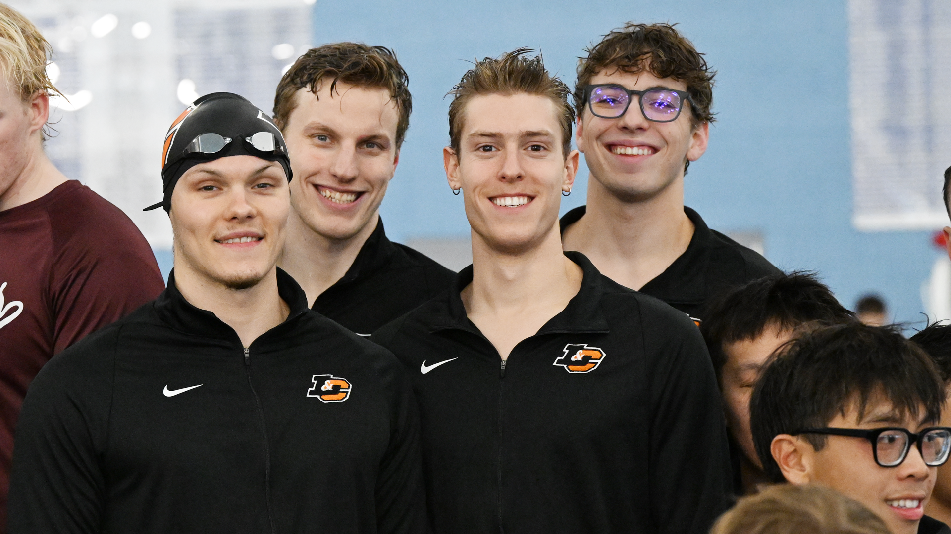 The men's 200 medley relay team poses for a photo after setting the program record at the conference championship meet