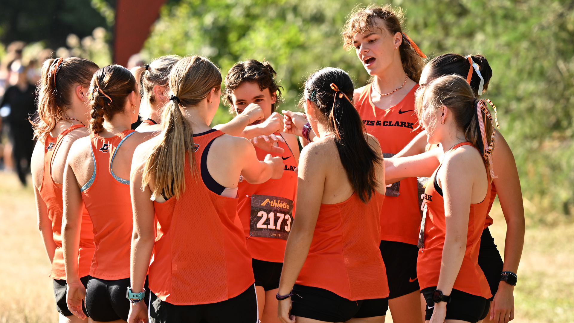 Women's cross country huddles up before a race