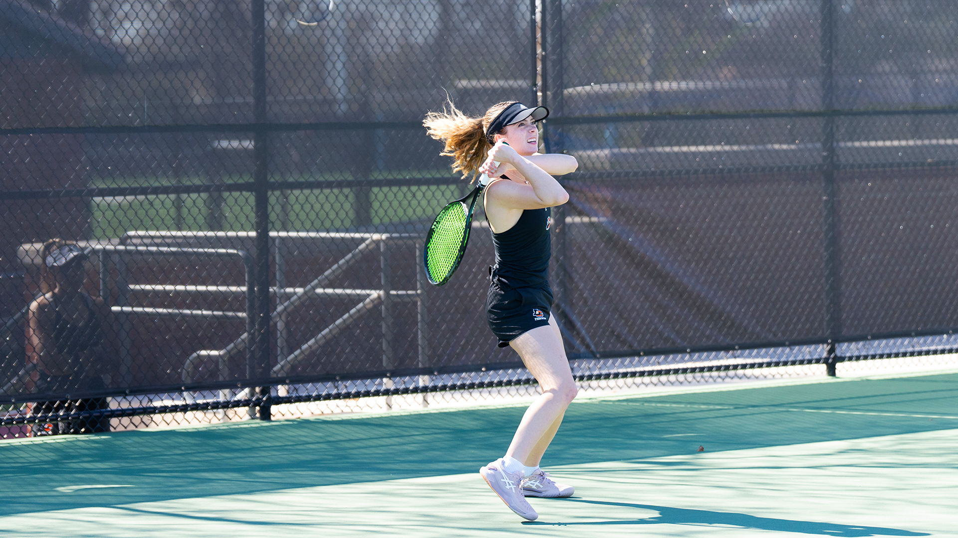 Anna English watches her baseline backhand go back over the net. 