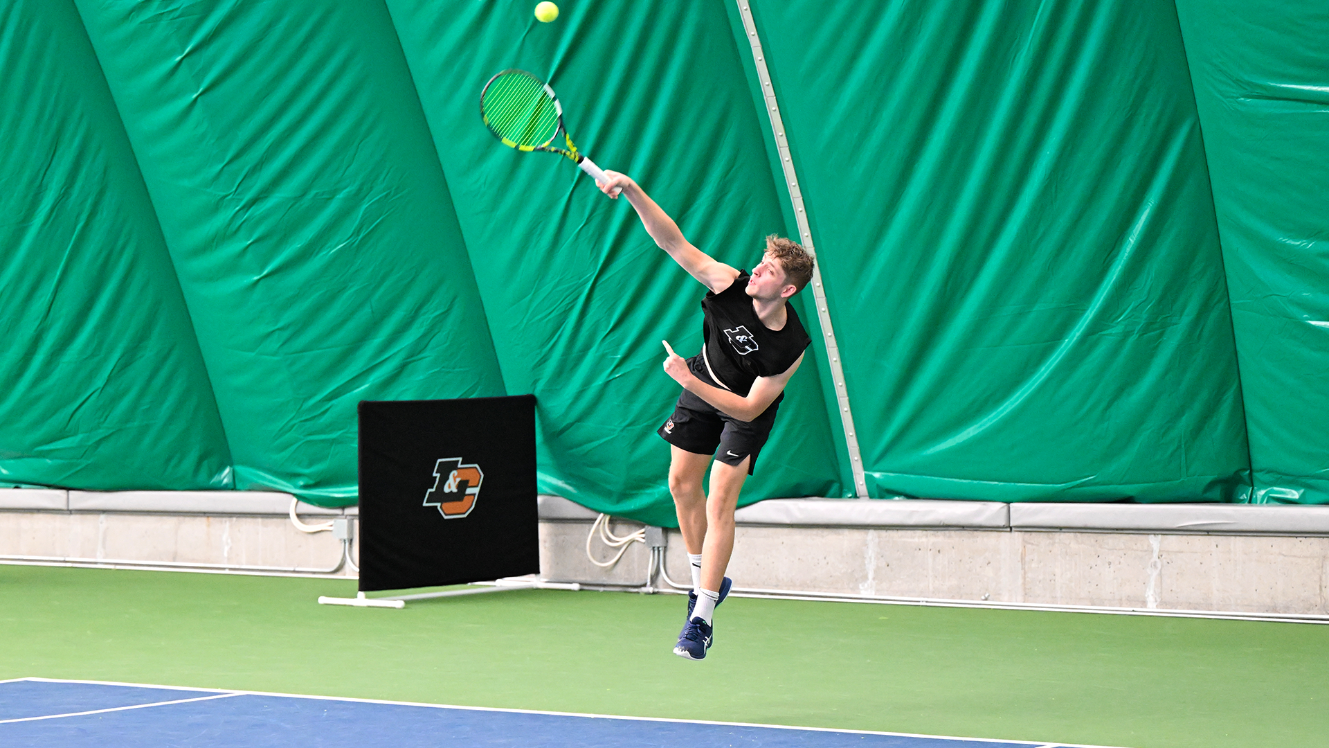 Spencer Loucks serves the ball in a recent match.