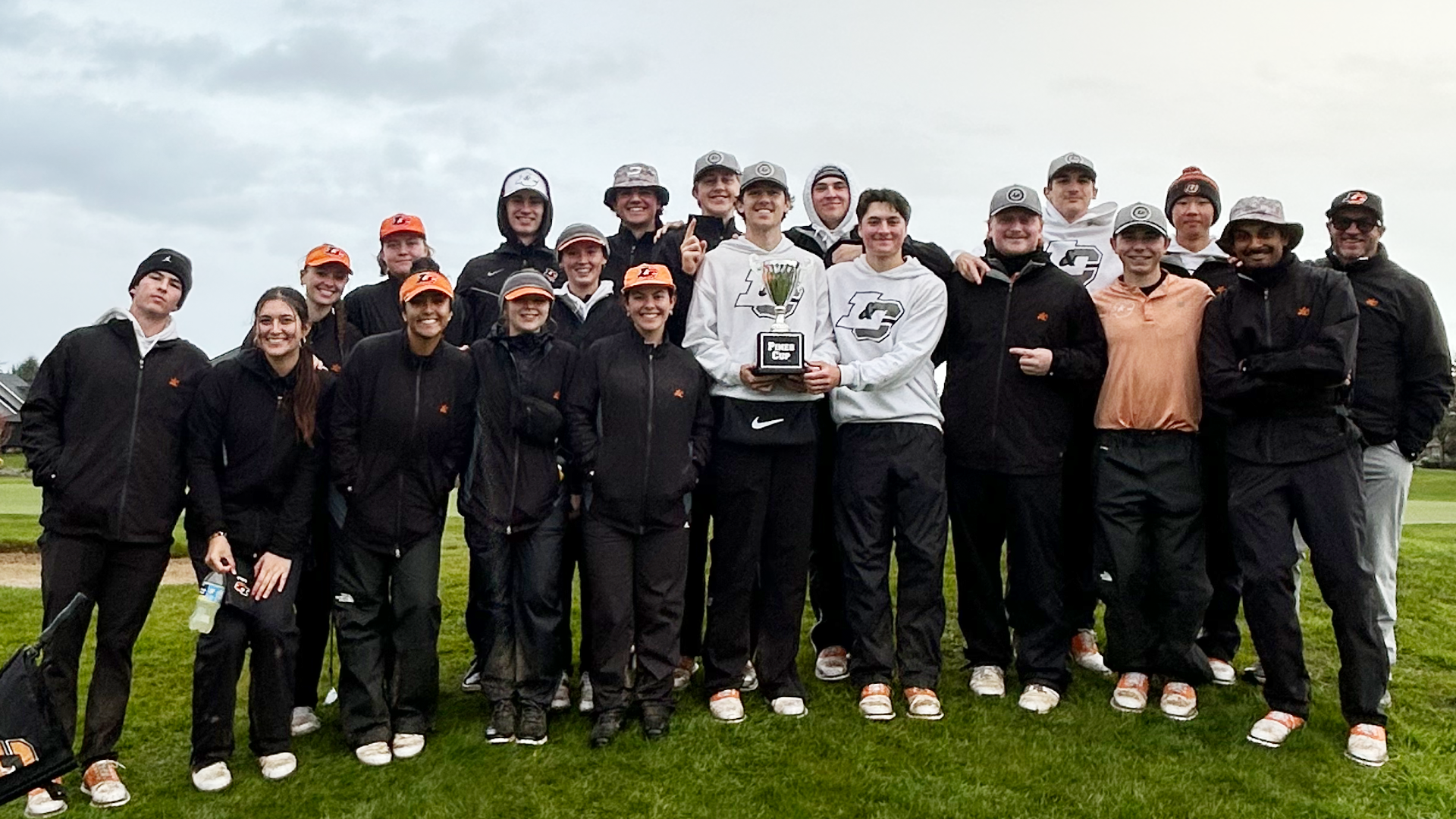 Men's and women's golf pose for a photo with the Pines Cup trophy 