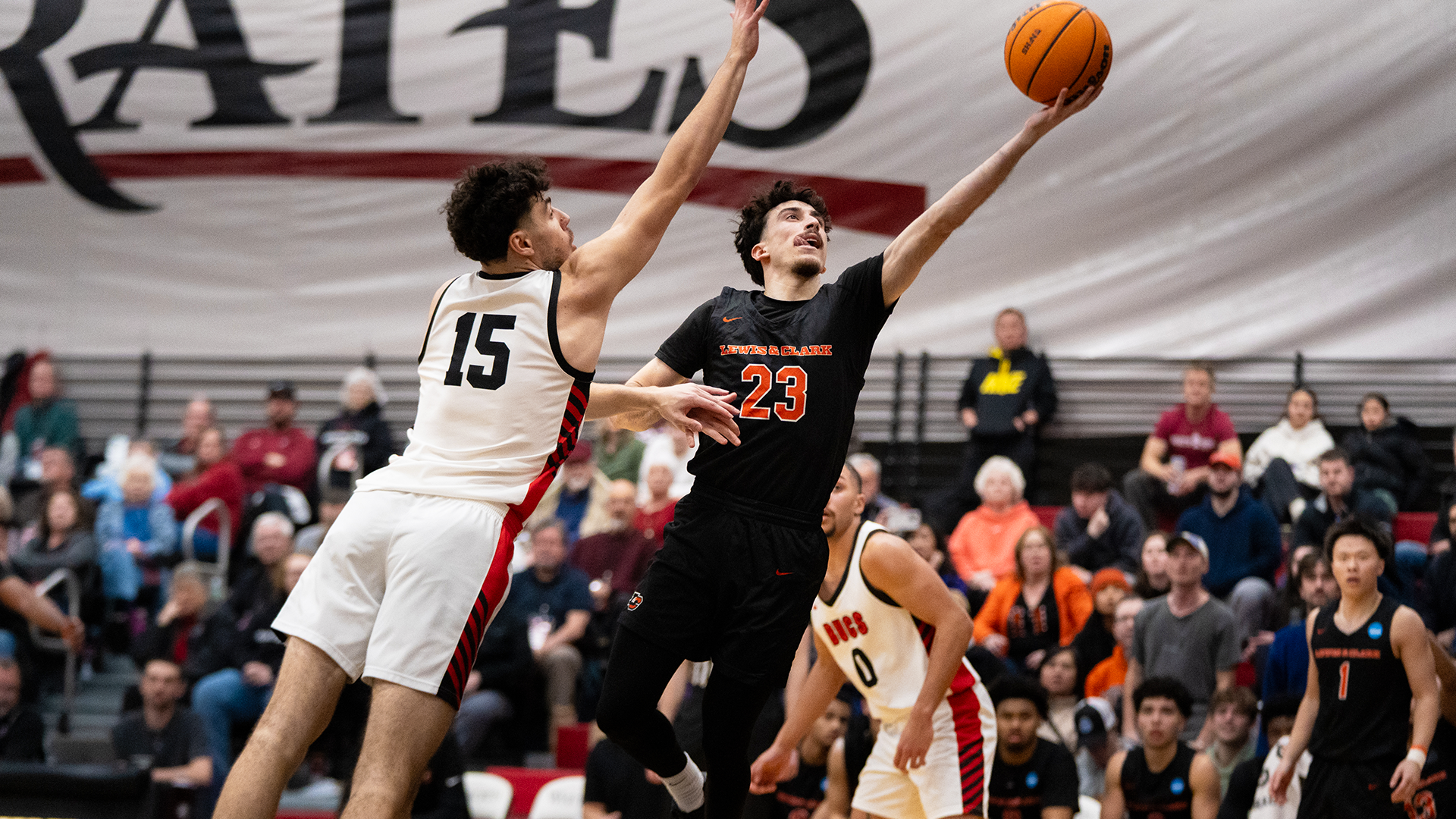 Yigit Arcan shoots a layup passed a defender. 