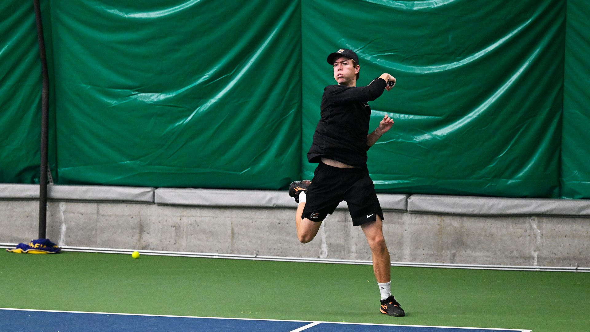 Kaden Sigurdsson hits a baseline forehand in a recent match. 