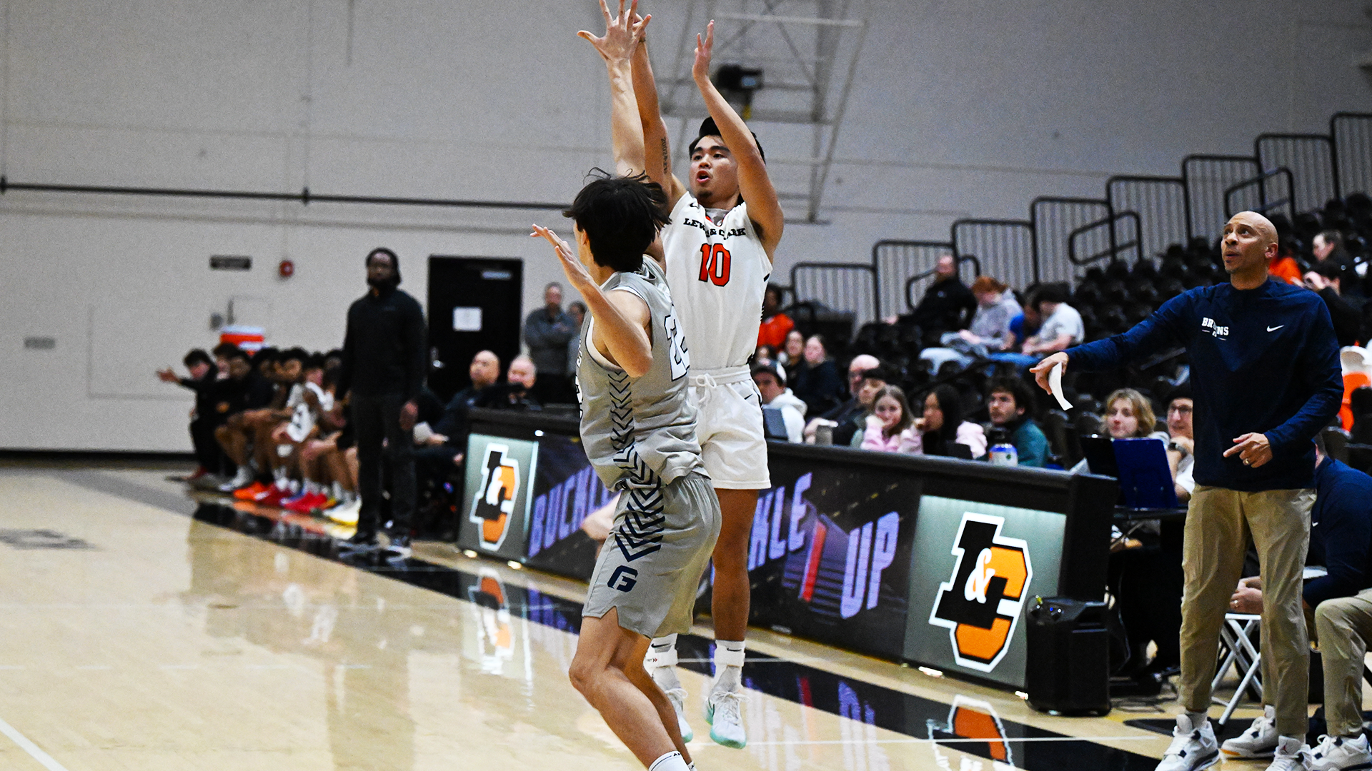 Kody Uyesugi shoots a three-pointer over a defender