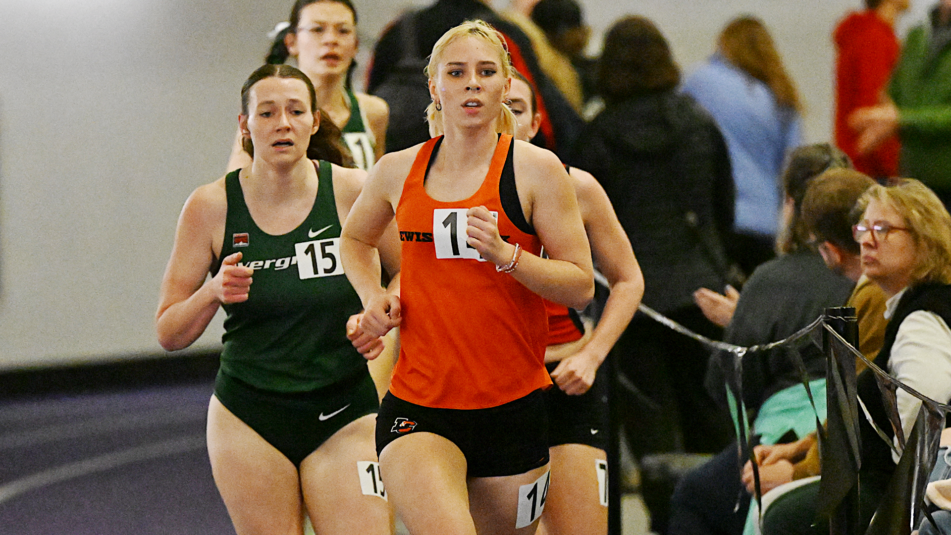 Miriam Reside runs ahead of a pack on the straightway at the University of Portland track