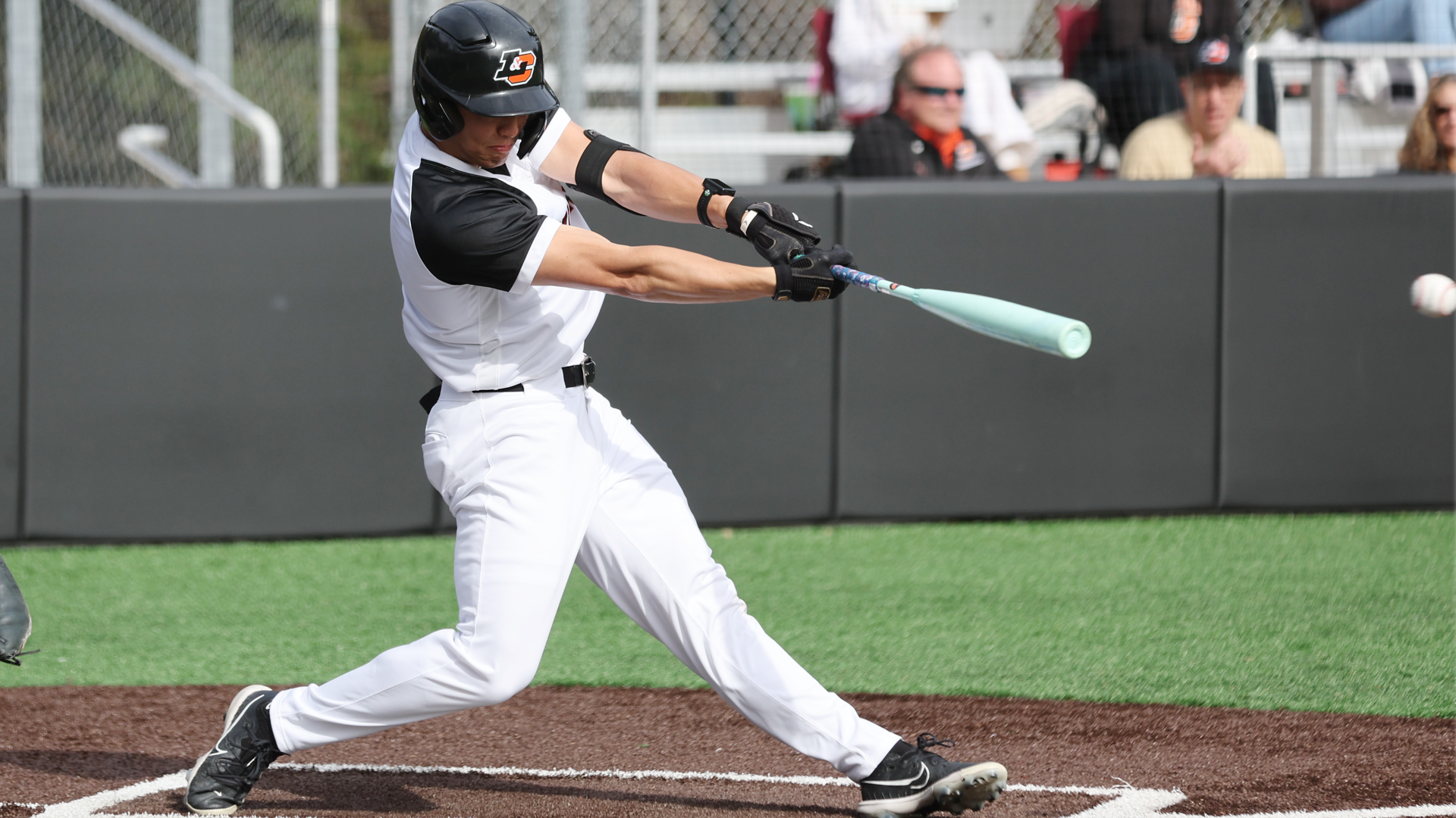 Michael Aikawa swings and hits a line drive