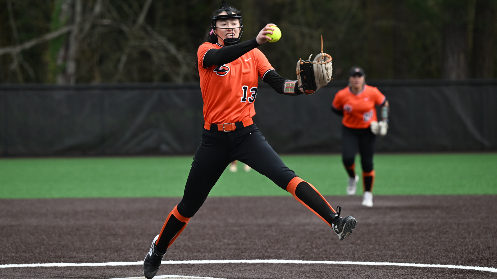 Charlize Pope throws a pitch against Whitworth