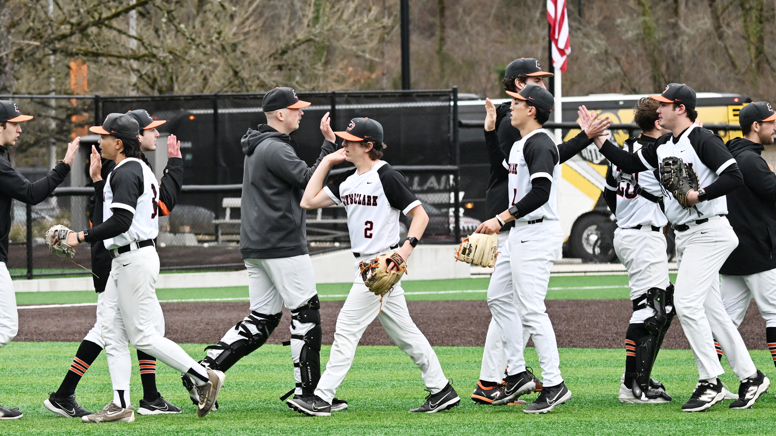 Baseball players high five in a line after a win