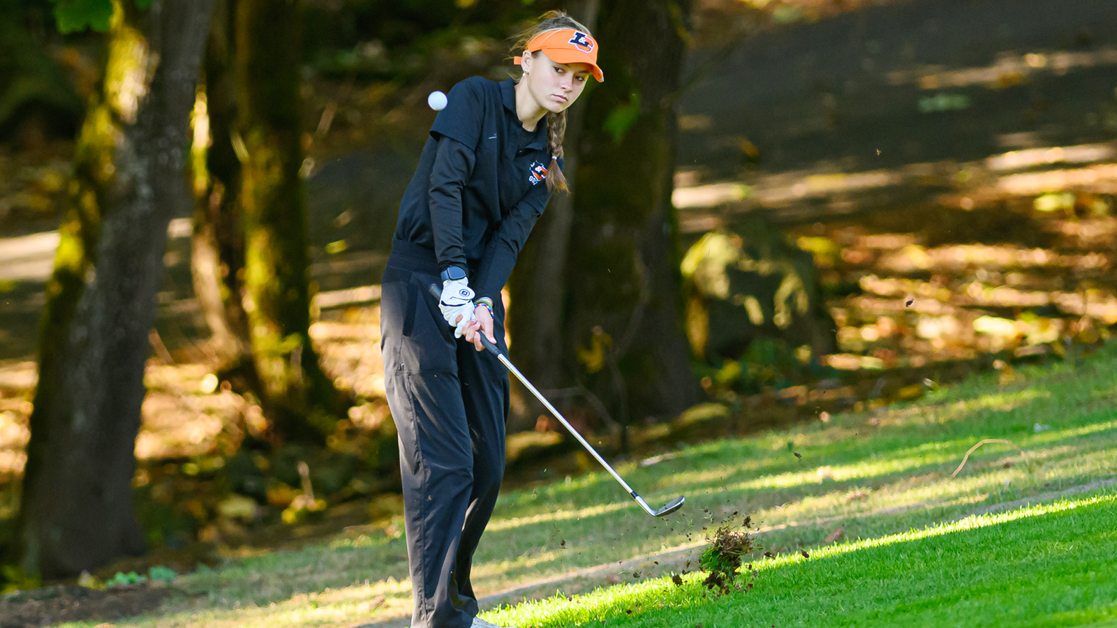 Kimber Yoder hits an iron shot and watches the ball fly in front of her