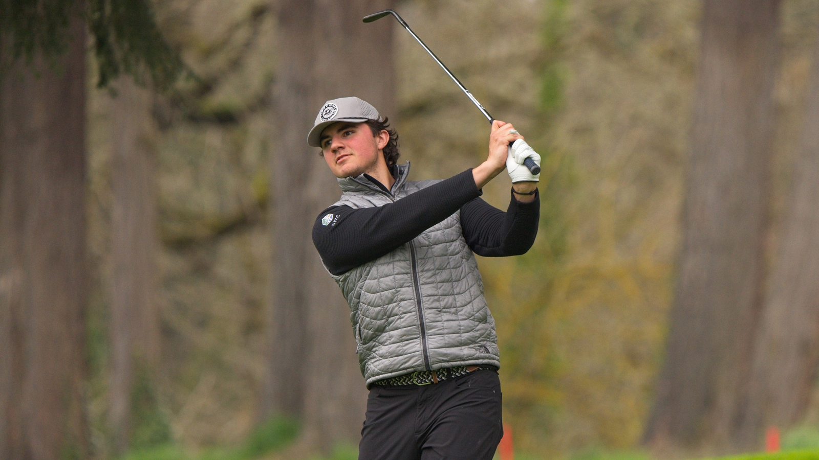 Mason Hill watches an iron shot fly towards the green