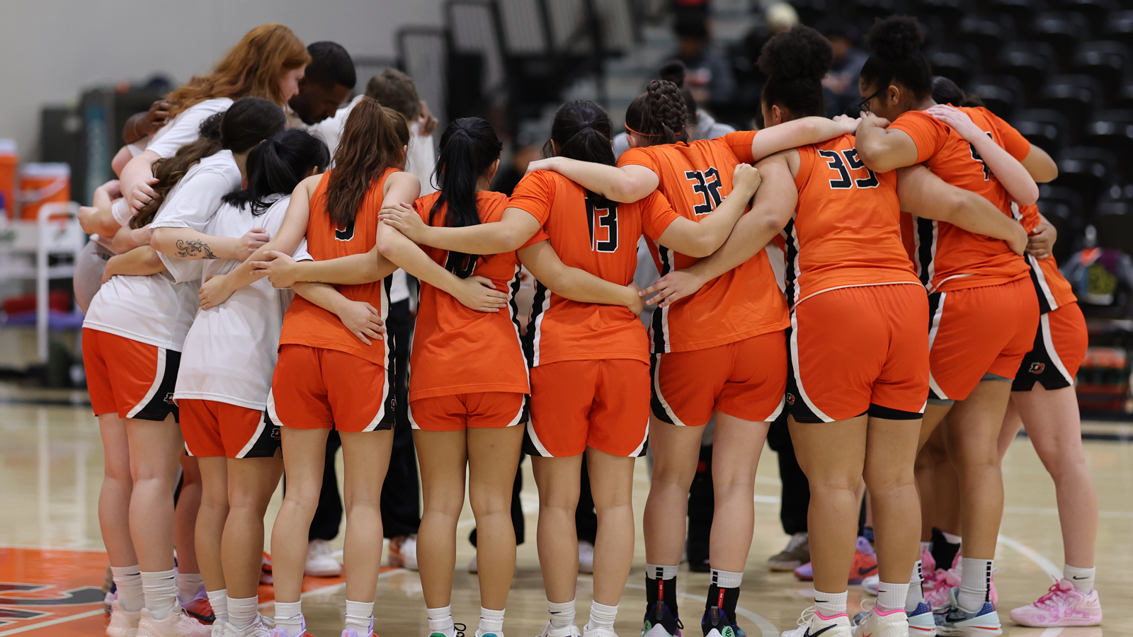 Women's basketball players huddle up before a game