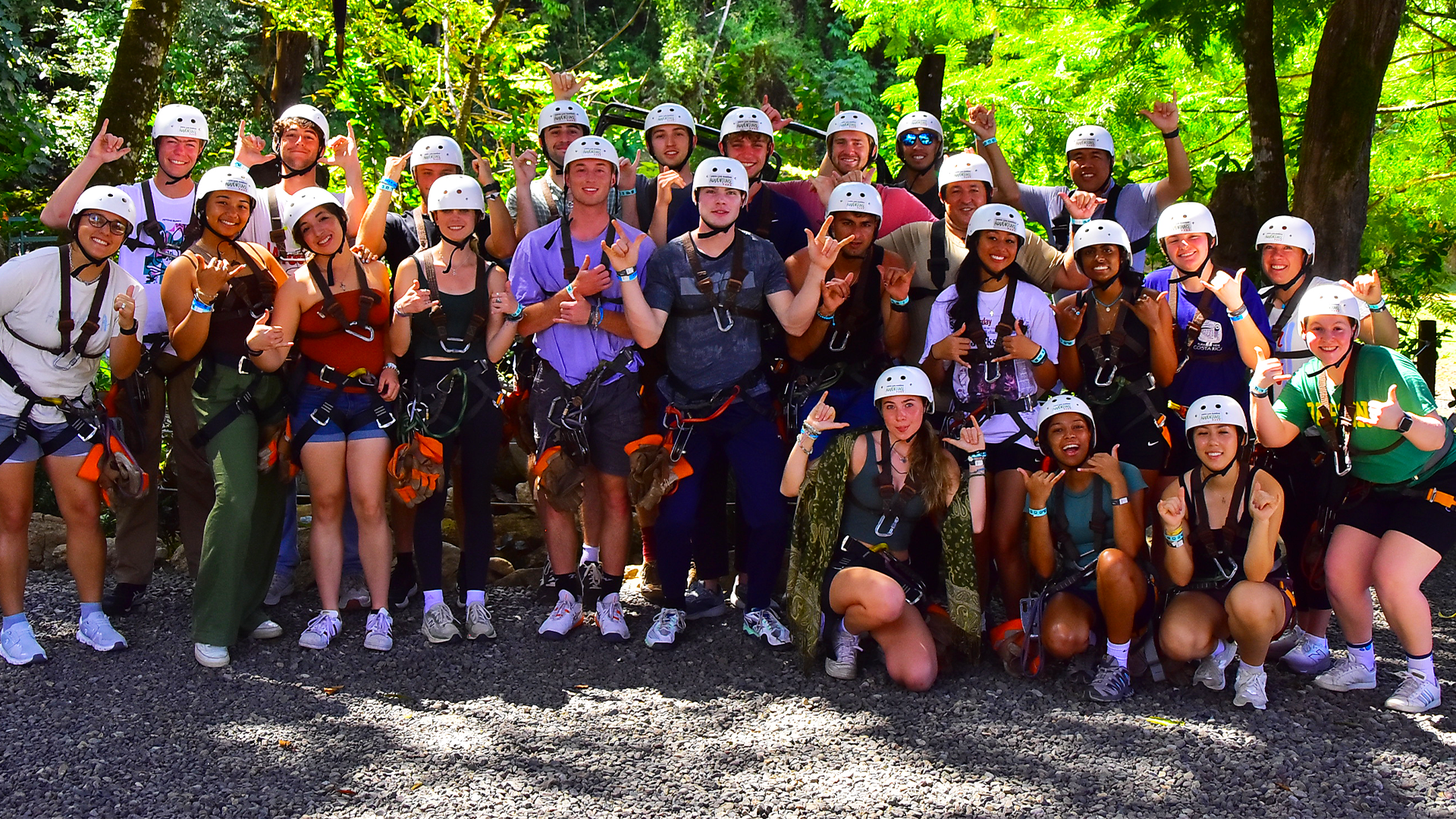 The men's and women's tennis teams pose after zip lining in Costa Rica