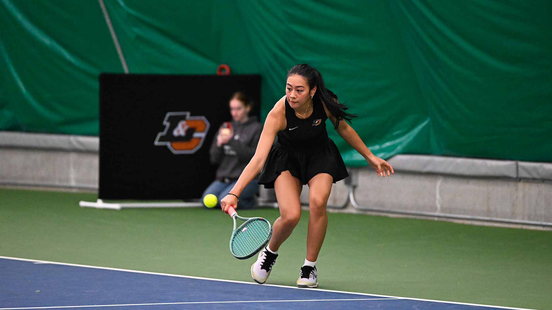 Charlotte Makoni crouches down for a baseline volley. 