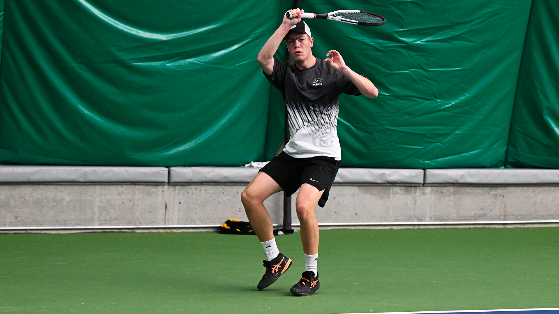 Kaden Sigurdsson hits a baseline forehand.