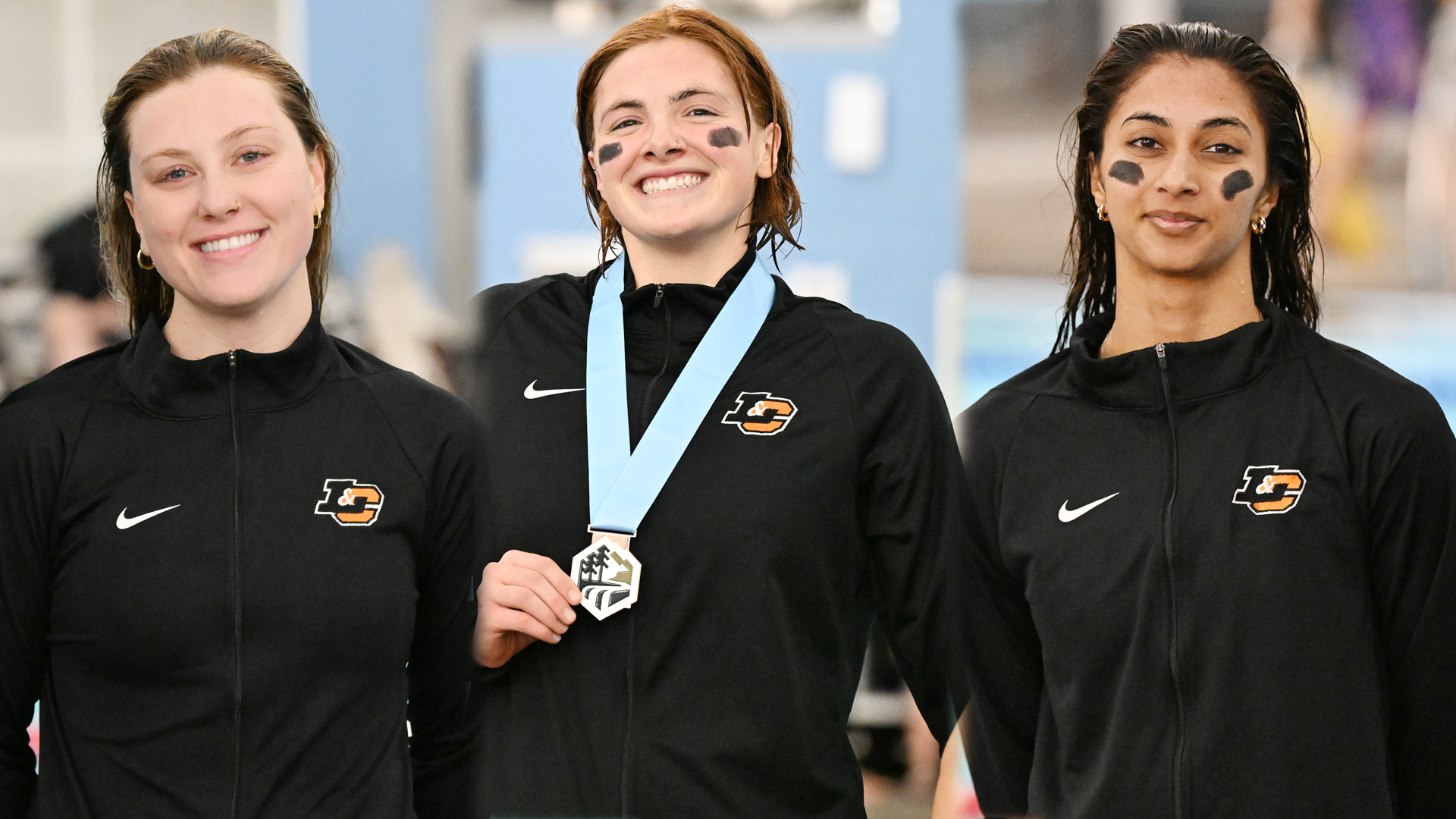 Angie Cummings (left), Elise Barton (center) and Aniqah Gafoor (right) pose for photos on the podium after earning All-Conference honors