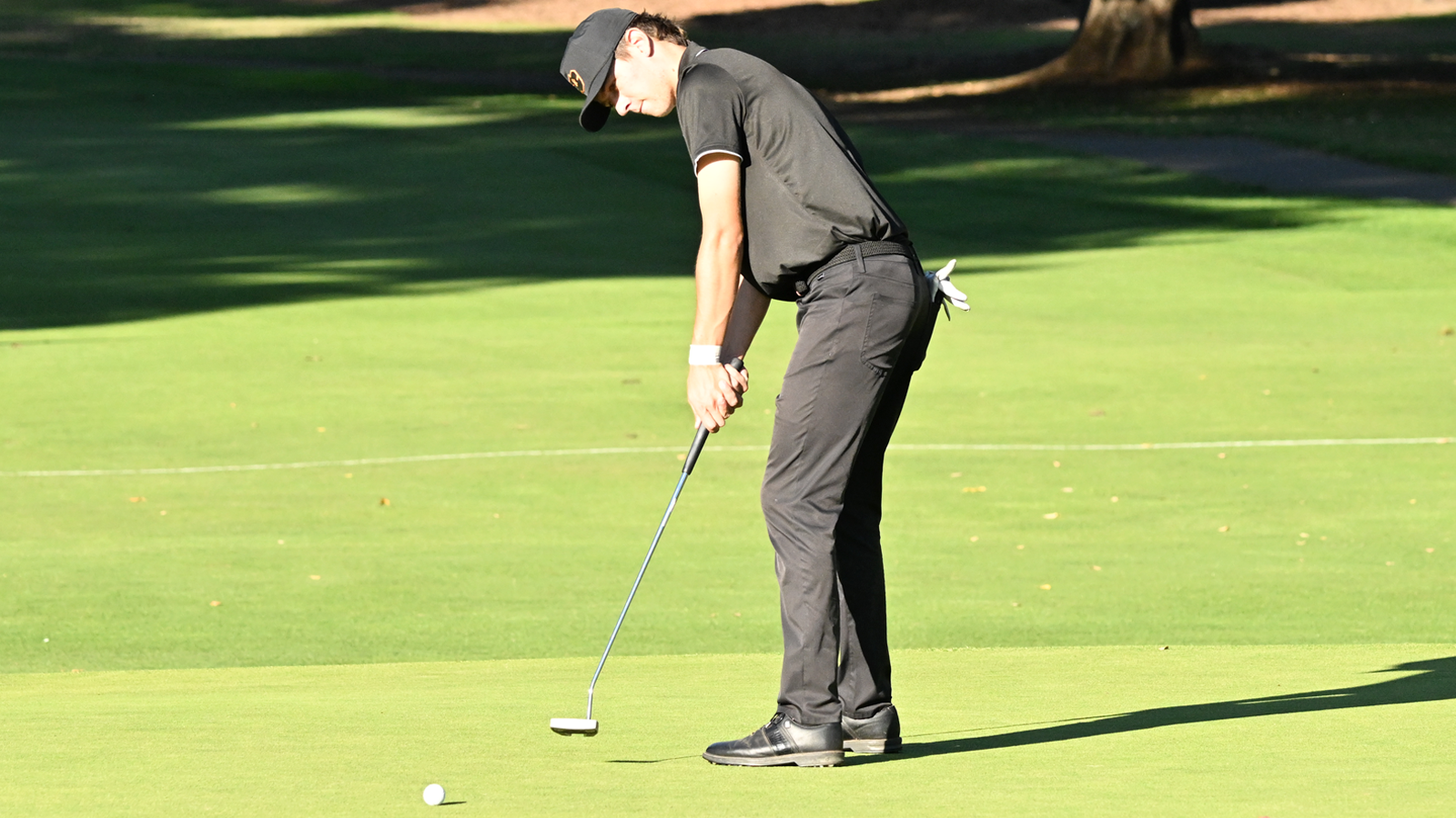 Kenji Pickeral putts the ball and watches the ball head towards the hole
