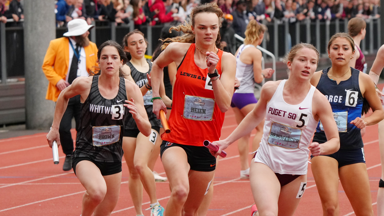 Malia Heien runs with the baton as the anchor leg of the 4x400M Relay 
